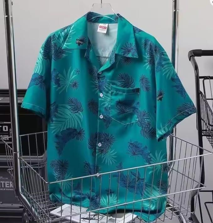 The teal Hawaiian-style shirt on a hanger, showing the relaxed fit and camp collar