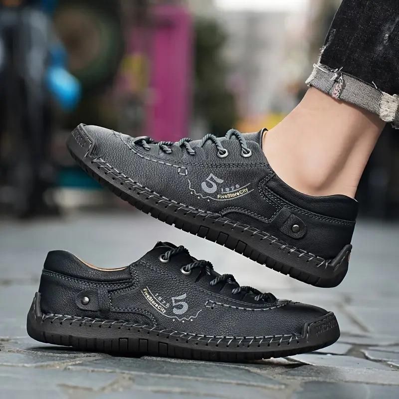 Black leather shoes with brand logo on a blurred background