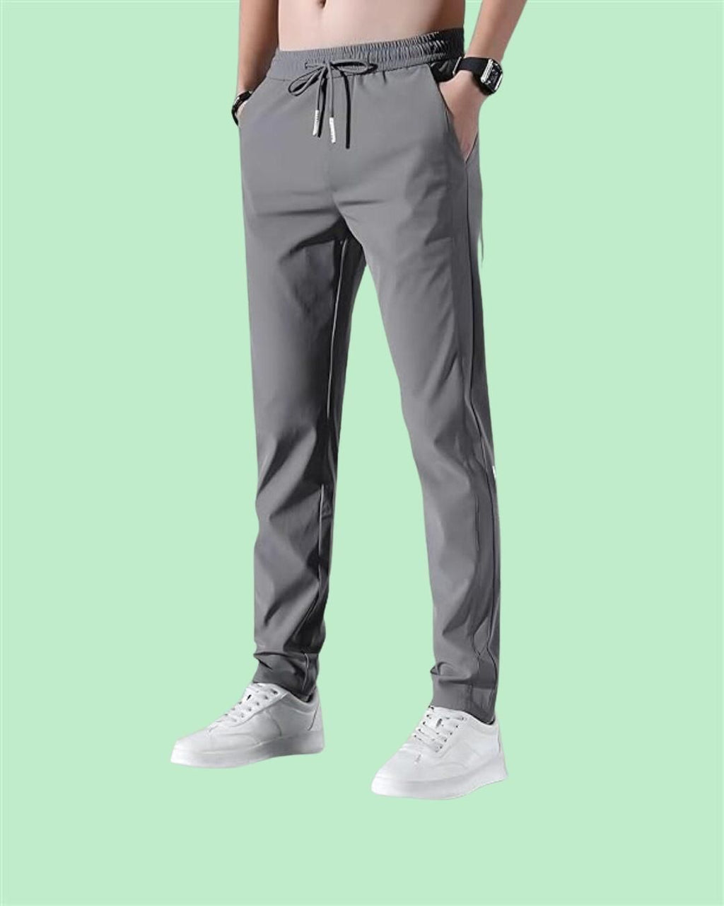 Model wearing the men's tapered athleisure track pants in grey.