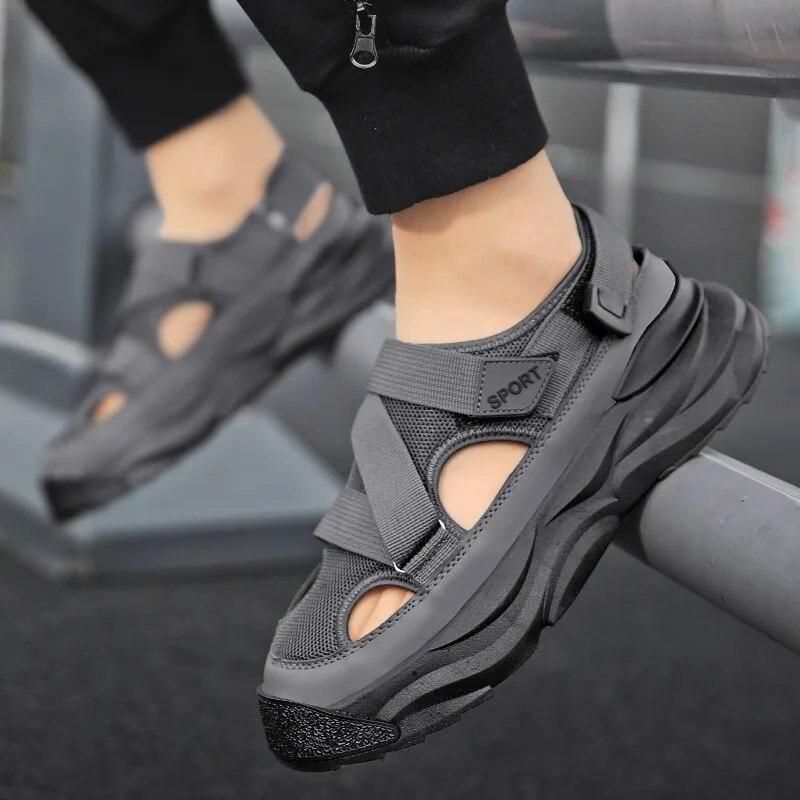Gray athletic shoes worn by a person on a treadmill.