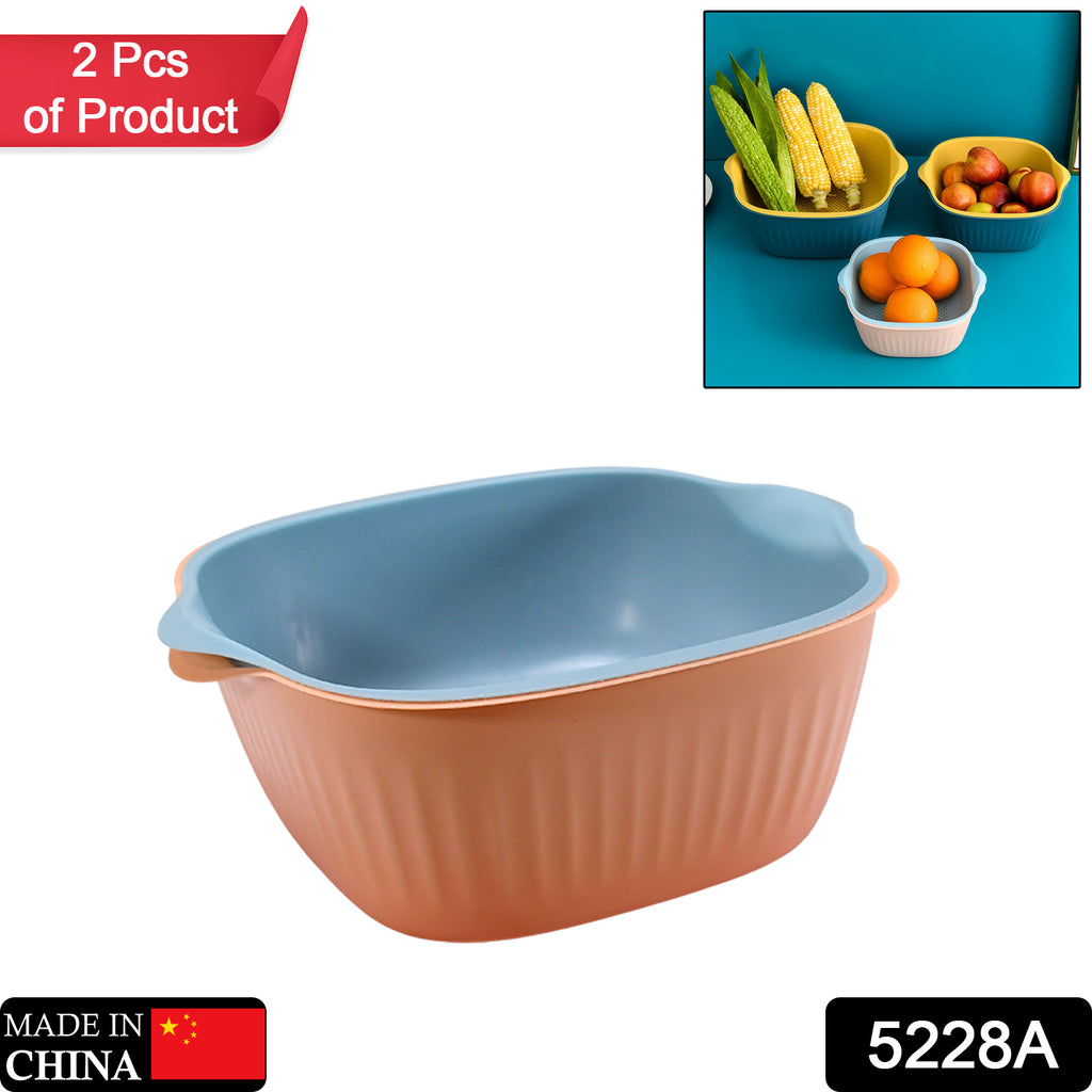 White plastic kitchen washing bowl with integrated strainer drainer basket for home use.