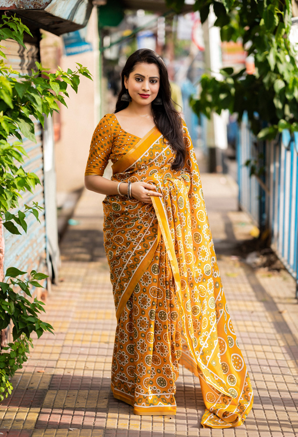 Vibrant Ajrakh style cotton print saree featuring traditional motifs and intricate patterns.