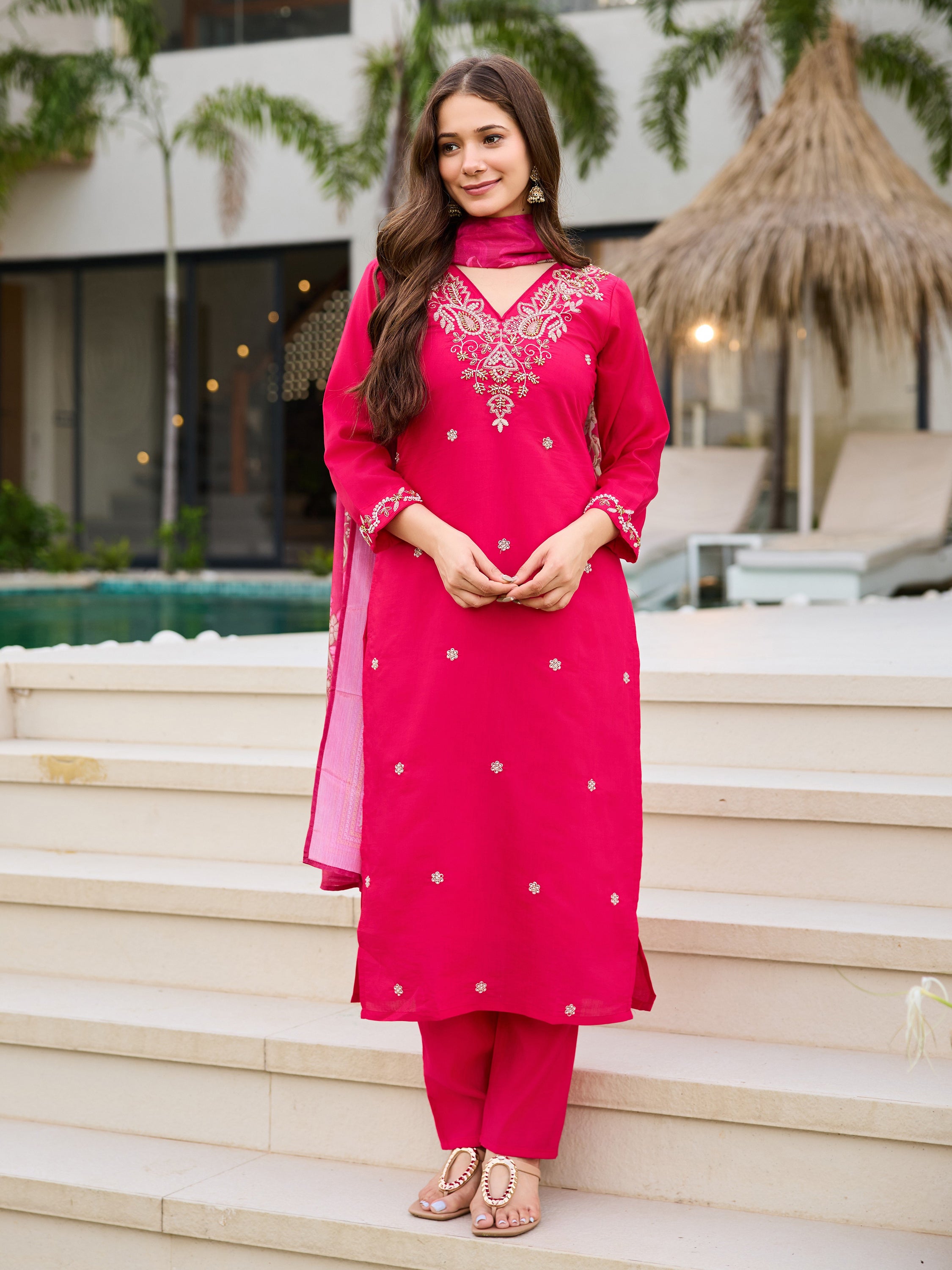 Woman standing confidently in the complete pink Roman silk embroidered kurti, pant, and dupatta set, showcasing the full outfit.