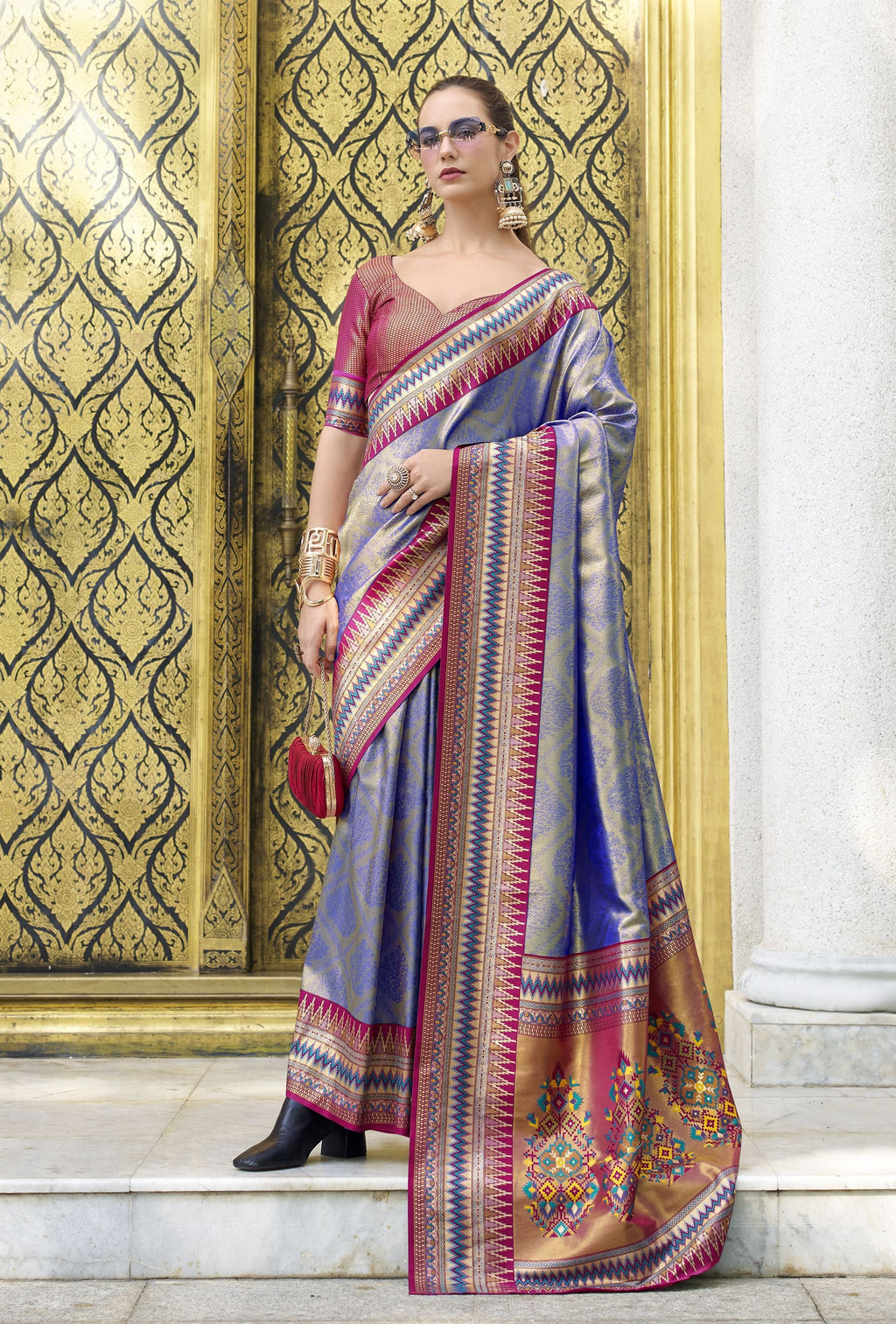 Blue soft tissue silk saree, elegantly draped, showcasing its smooth fabric and delicate sheen.