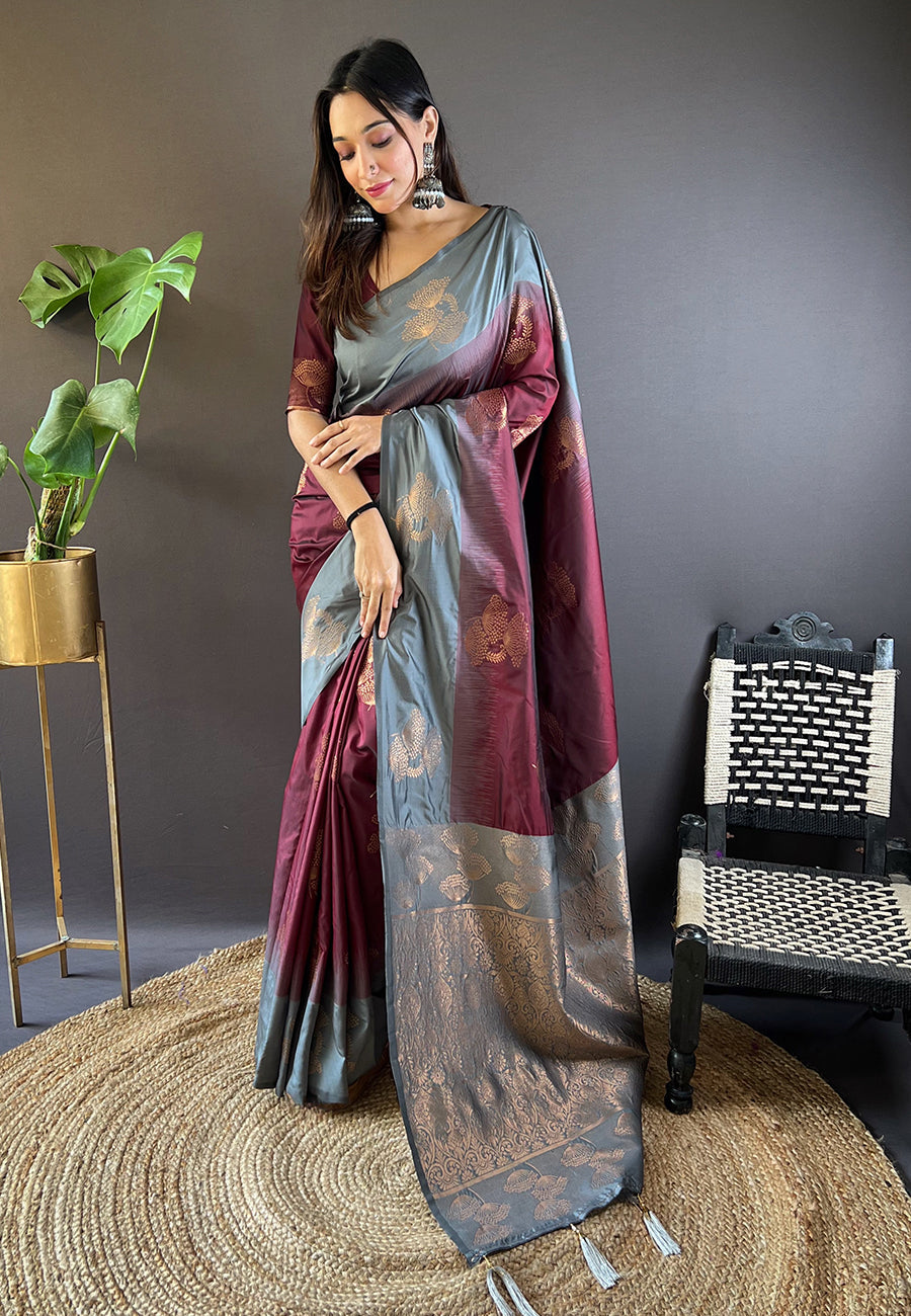 Brown soft silk saree with floral border and contrast zari weaving.