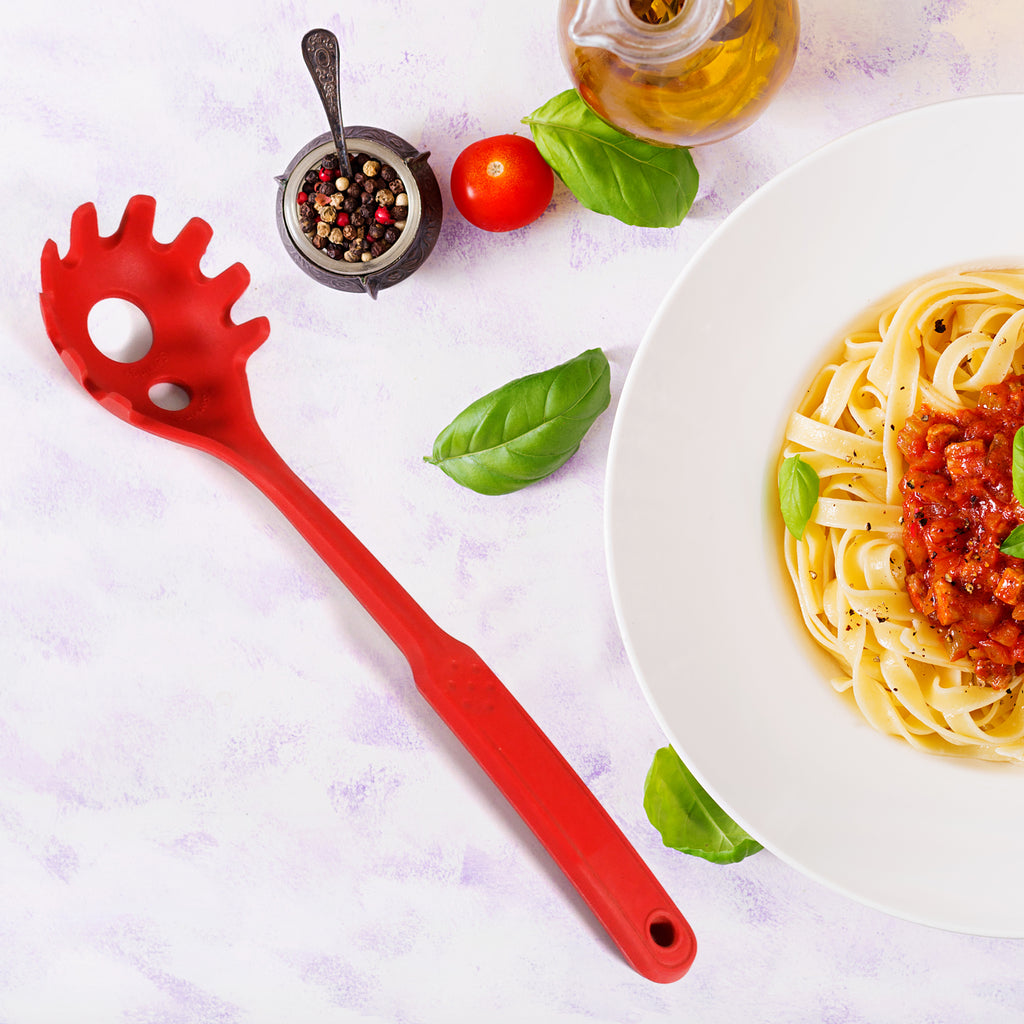 Close-up of the smooth, flexible red silicone spoon head showing its seamless non-stick edge