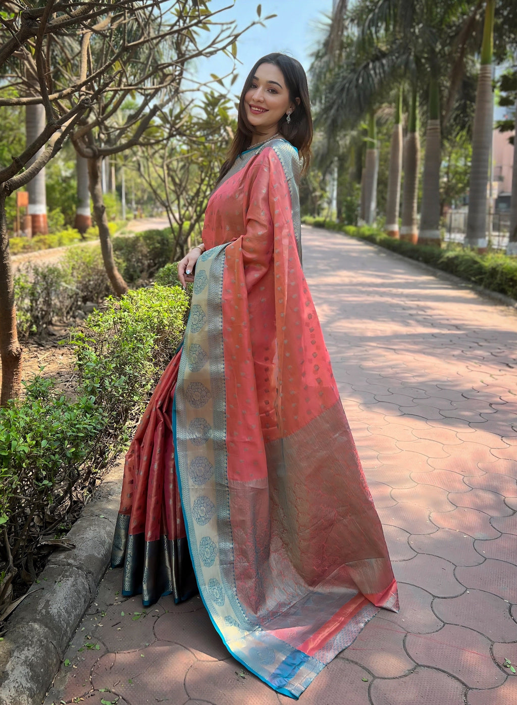 Lustrous Coral Kanchipuram Tissue Silk Saree with exquisite Zari weaving