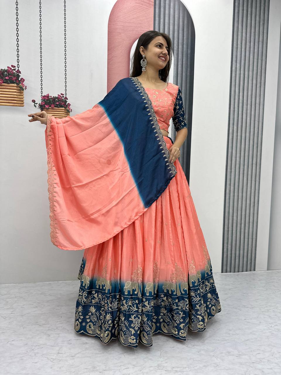 Model wearing coral and blue embroidered lehenga choli for wedding