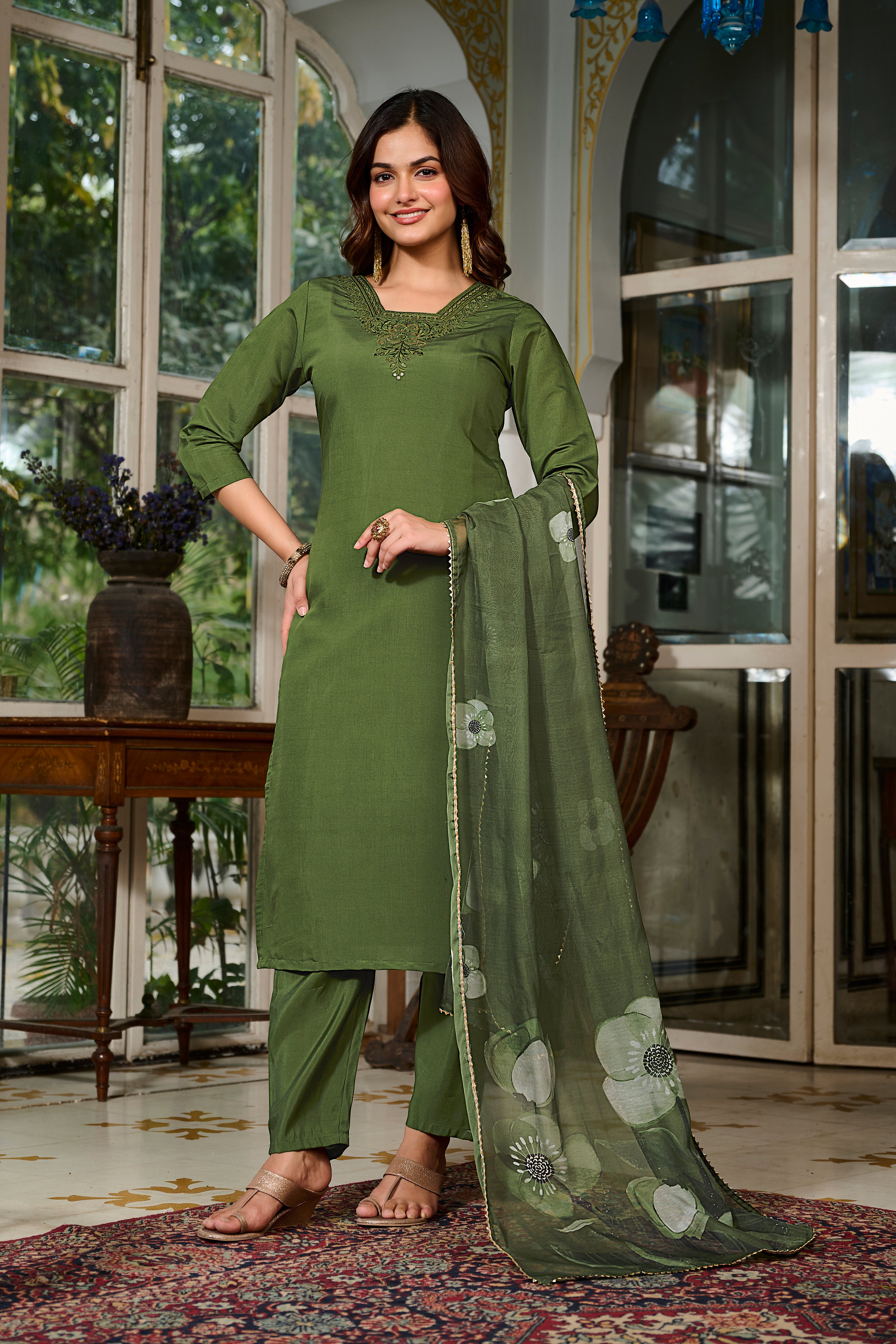 Fashionable model posing confidently in the TRENDBUY D125 green kurta, pant, and dupatta set, highlighting the outfit's elegant silhouette
