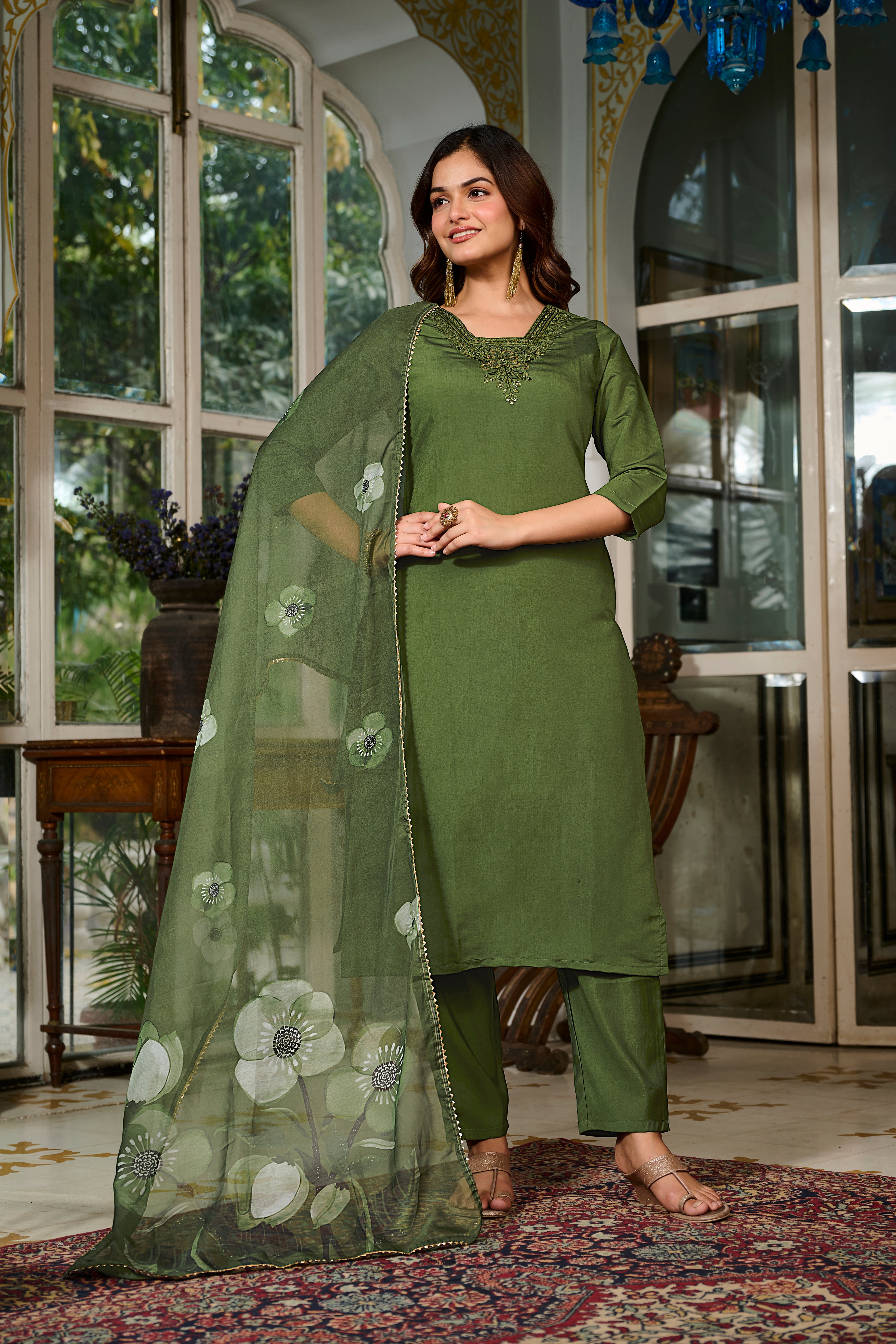 Full body shot of the model wearing the TRENDBUY green kurta set, emphasizing the embroidery and the drape of the floral printed dupatta