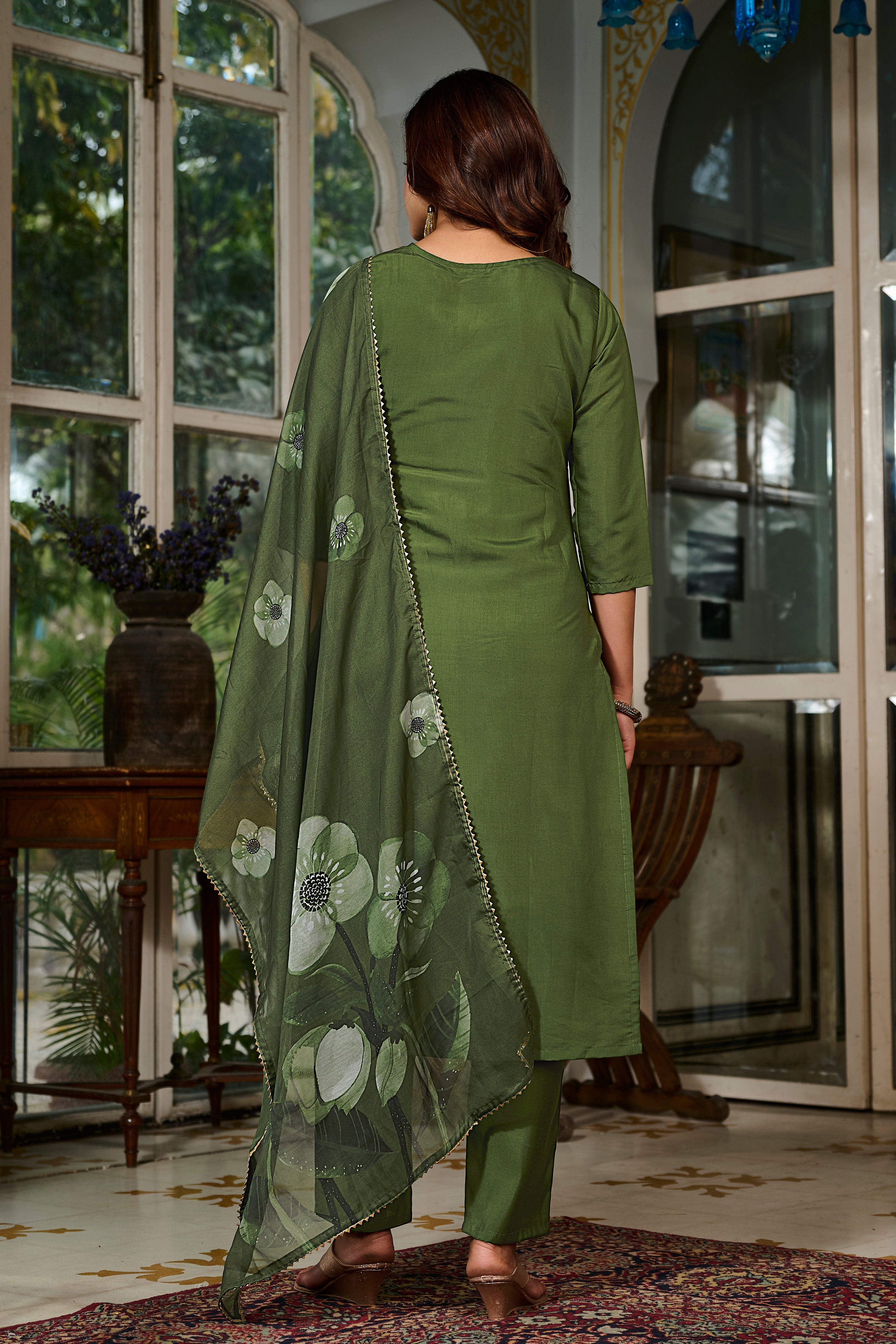 Back view of the model wearing the TRENDBUY green Viscose Chanderi kurta set, highlighting the simple yet elegant back design and dupatta