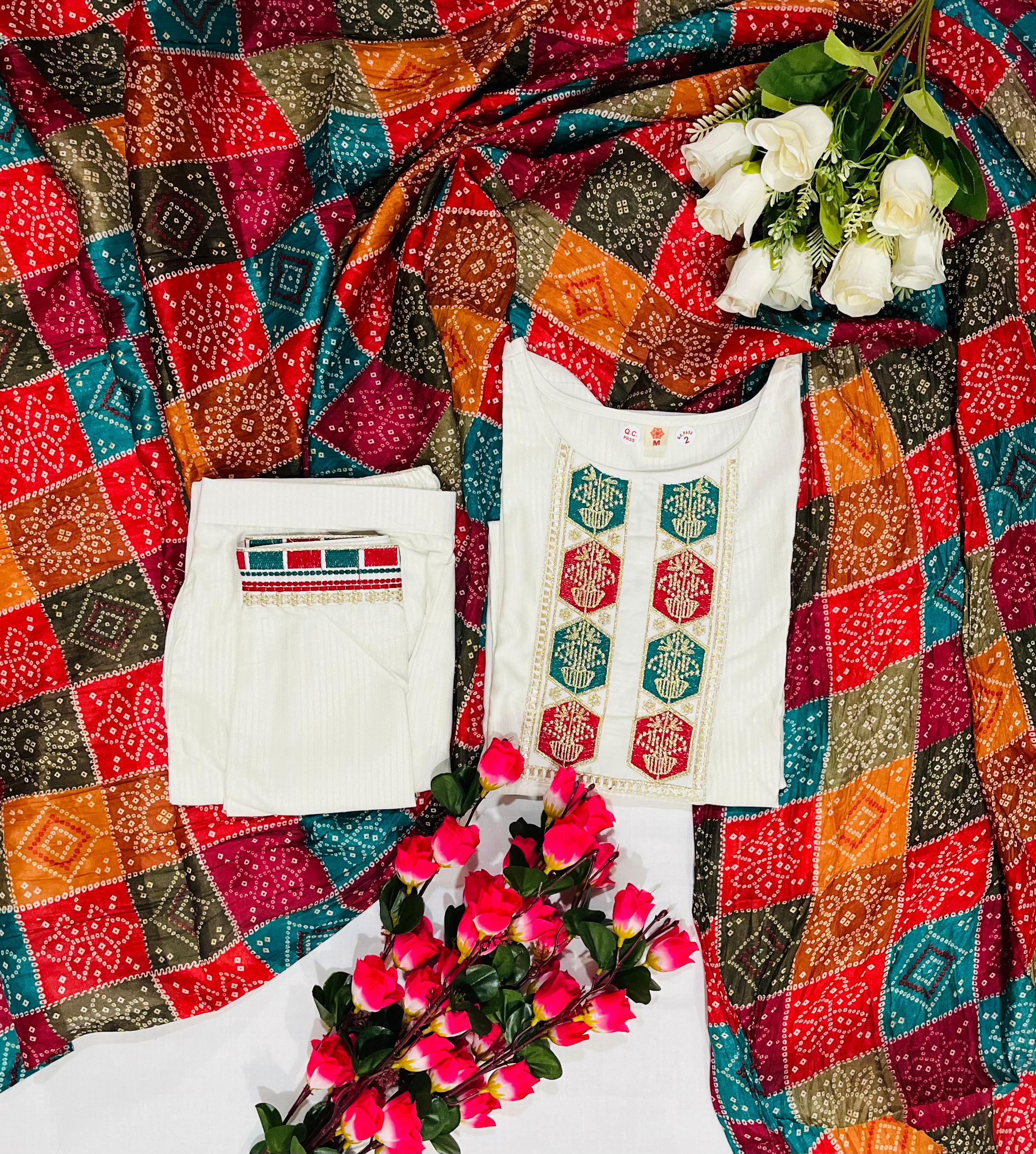 TRENDBUY D488 Off-White Kurta Set, top down view with embroidered kurta, viscose pants, and vibrant silk blend dupatta on a pattern fabric.