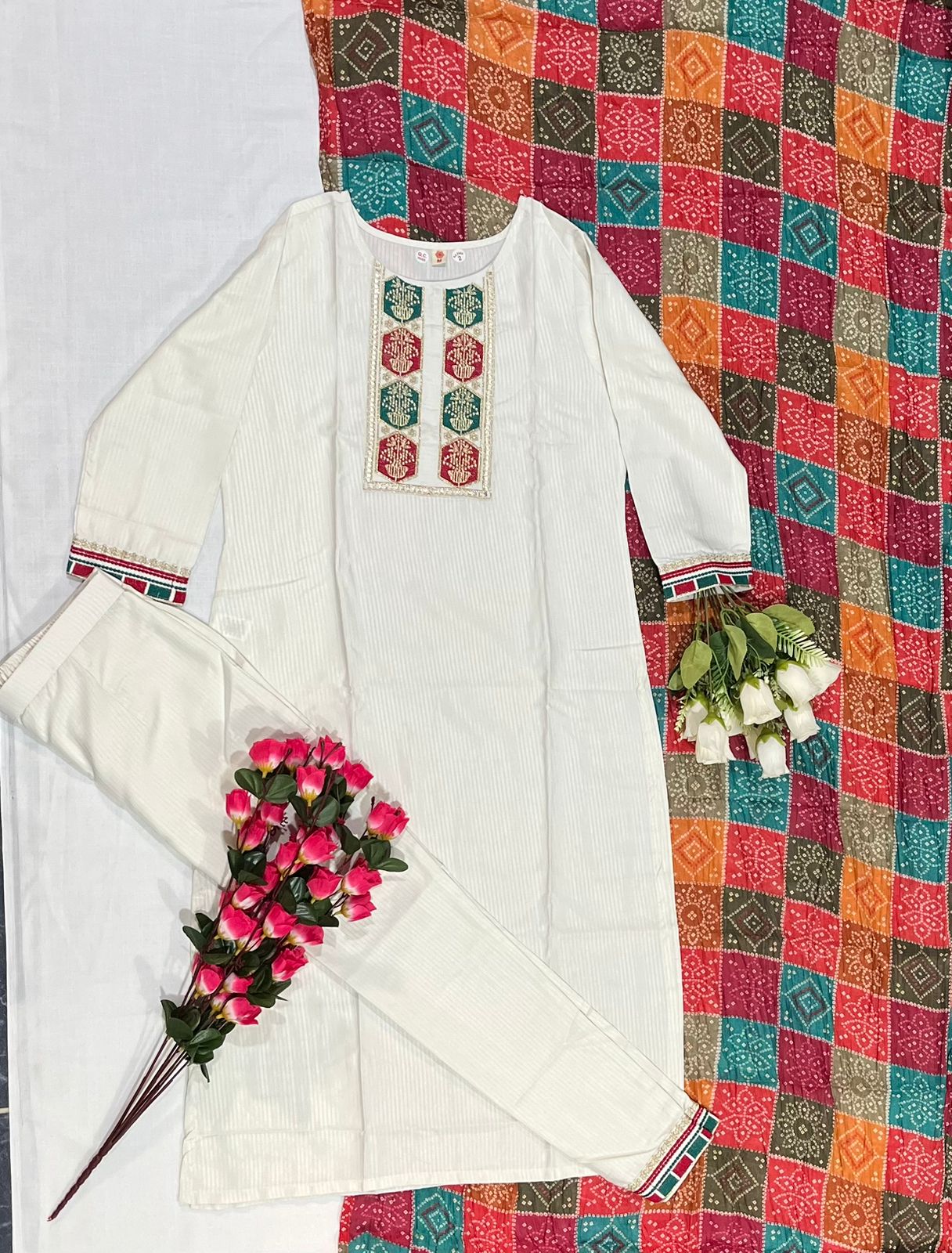 Flat lay of TRENDBUY D488 Off-White Viscose Kurta and Pant set with full sleeves, intricate embroidery, and colorful silk blend dupatta.