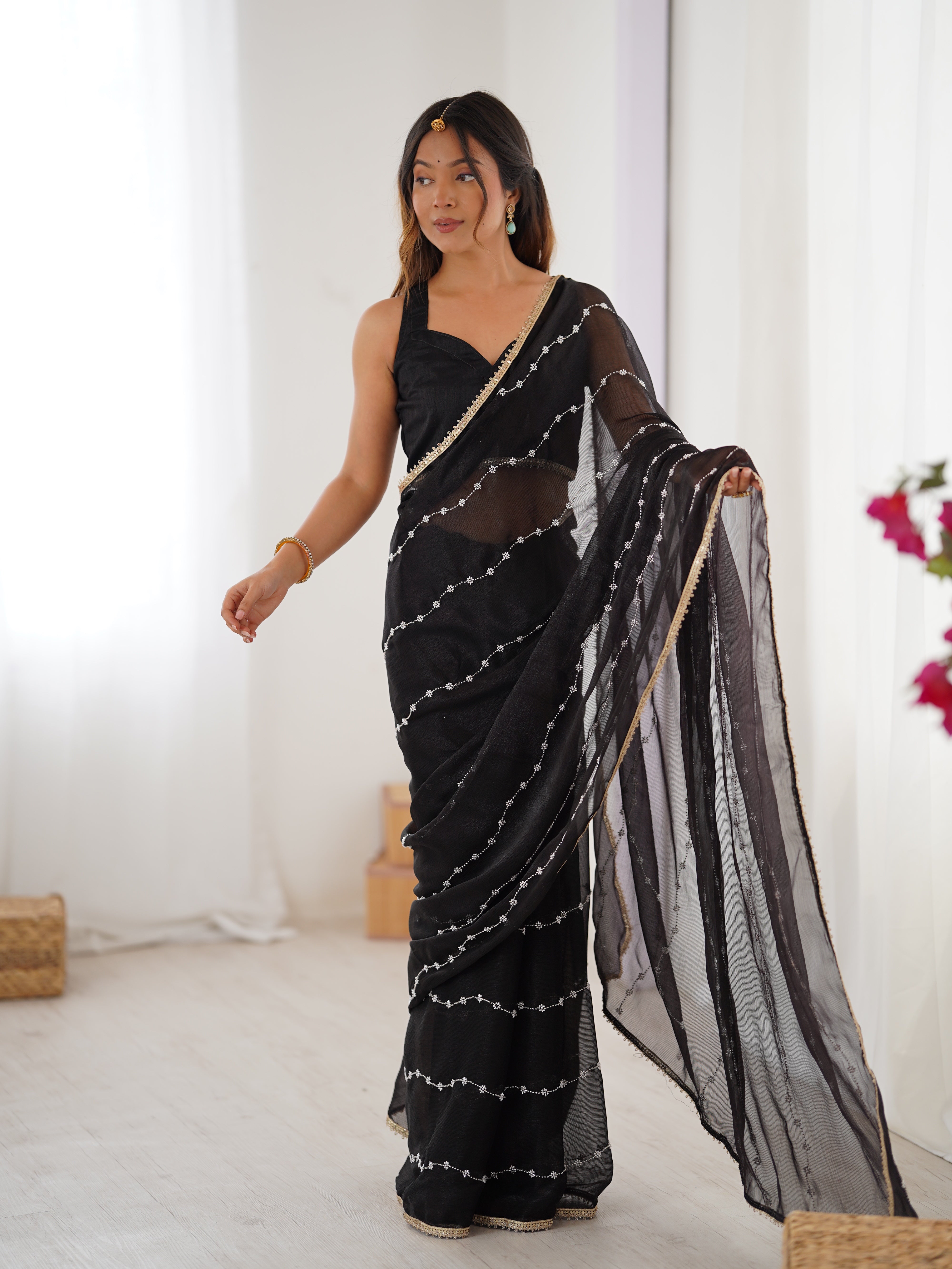 Black designer saree, close-up of intricate sequin and bead work on Sitara fabric.