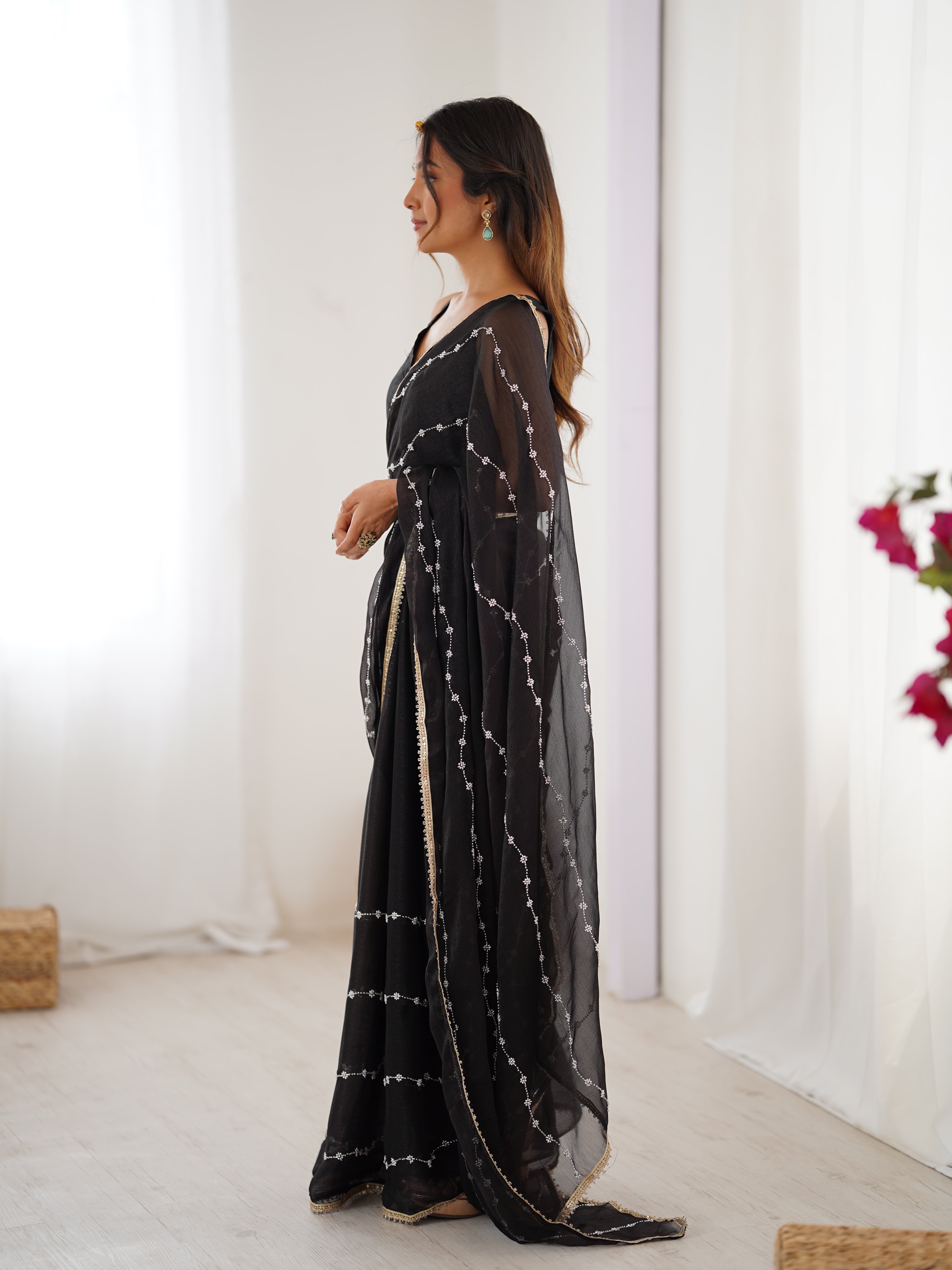 Back view of model in Black Sitara Saree, showcasing pallu and full length.