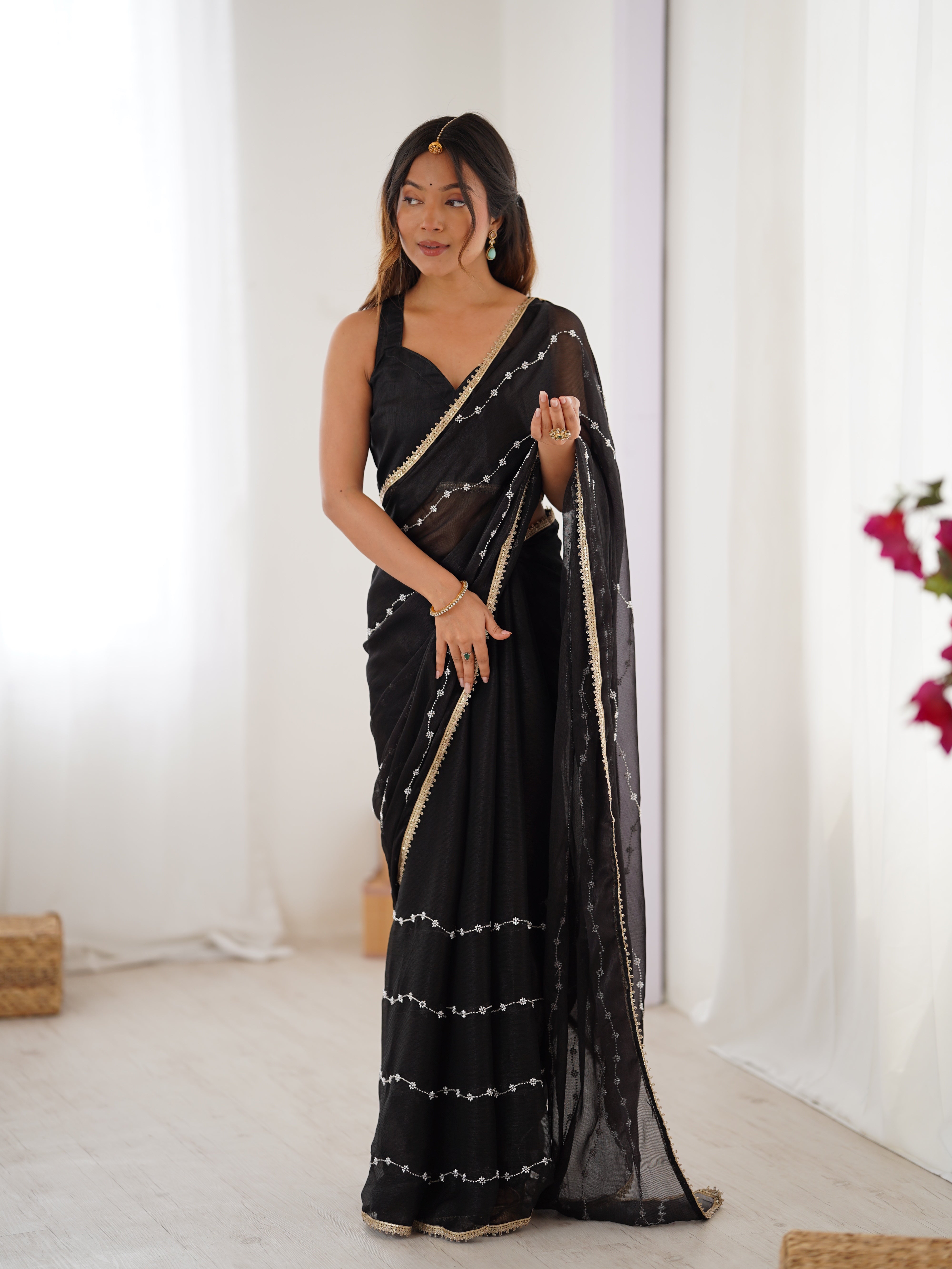 Model posing confidently in Black Sitara Fabric Saree, highlighting embellishments.