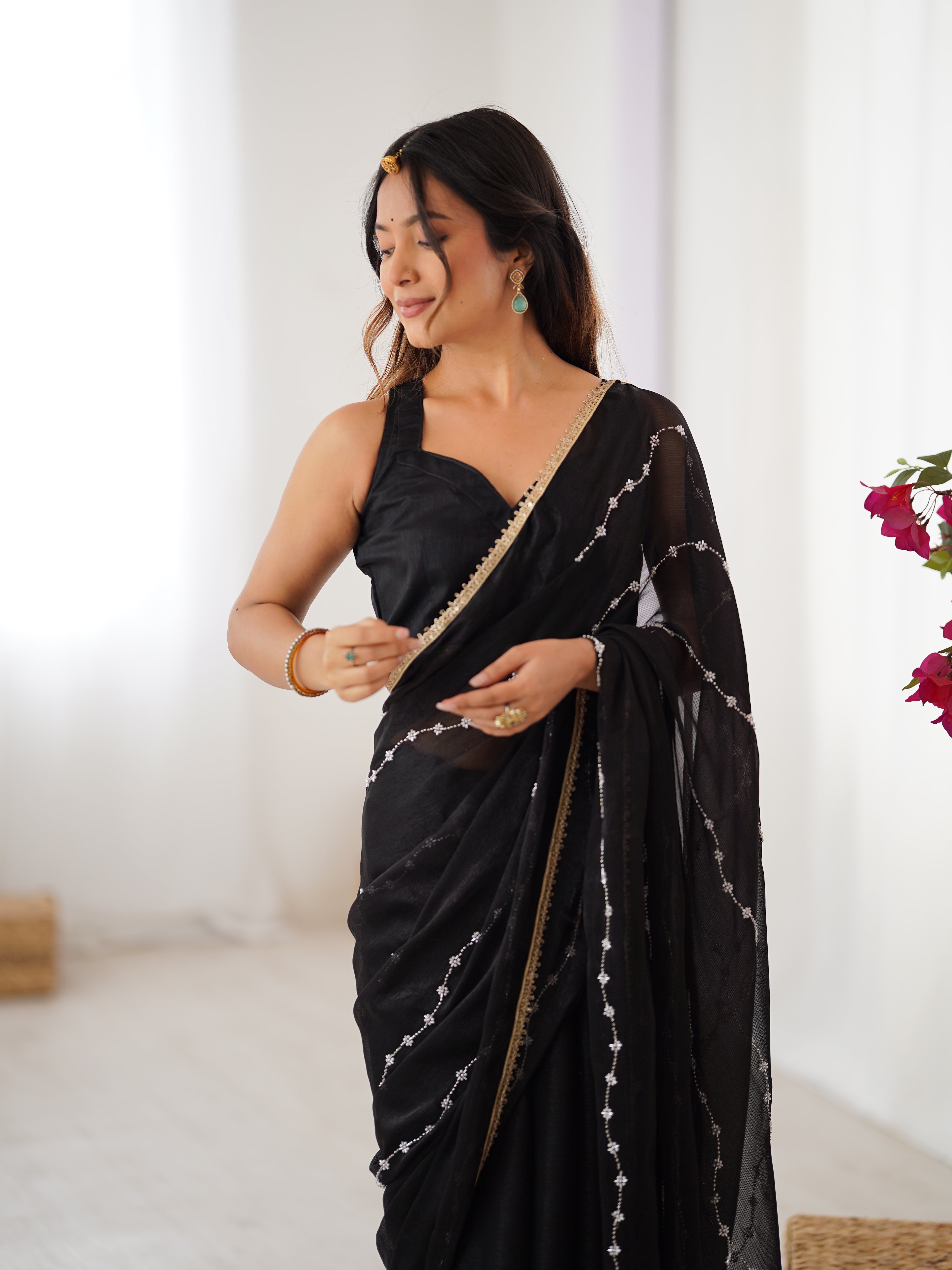 Detailed shot of Black Sitara Saree's border and matching unstitched blouse with lace.
