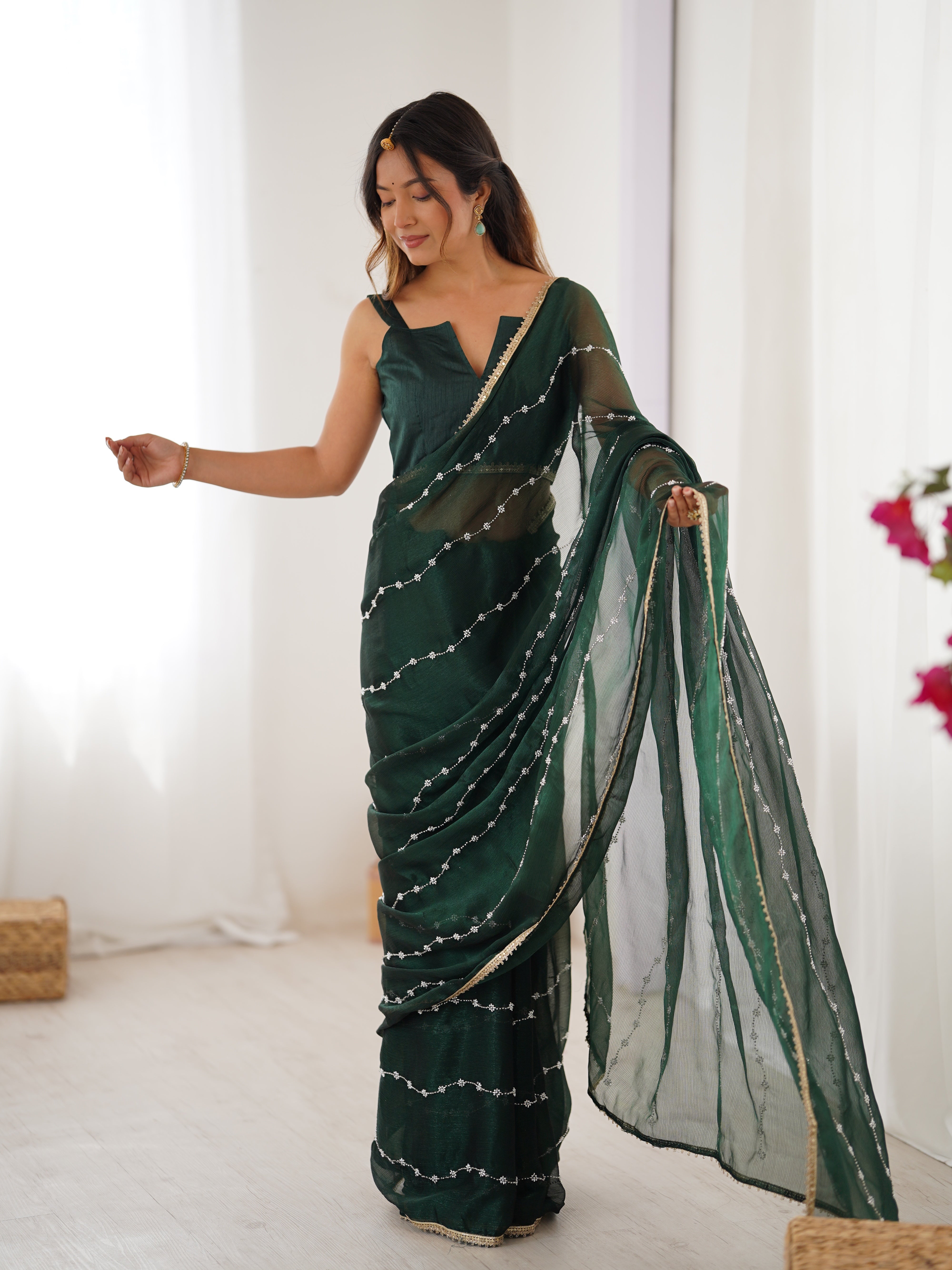 Model in Green Sitara Saree, side profile showing graceful drape and bead work.