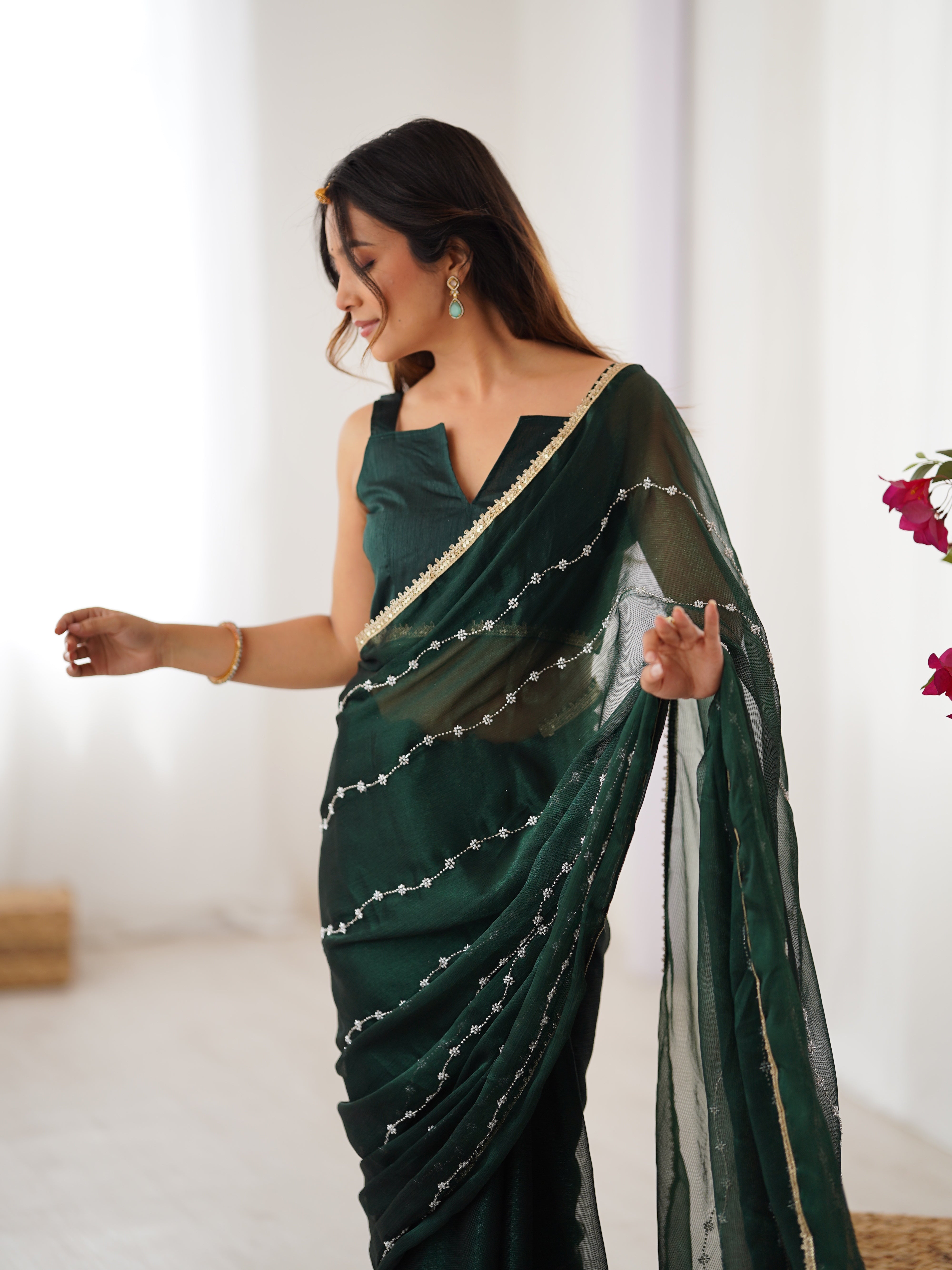Green designer saree, close-up of intricate sequin and bead work on Sitara fabric.