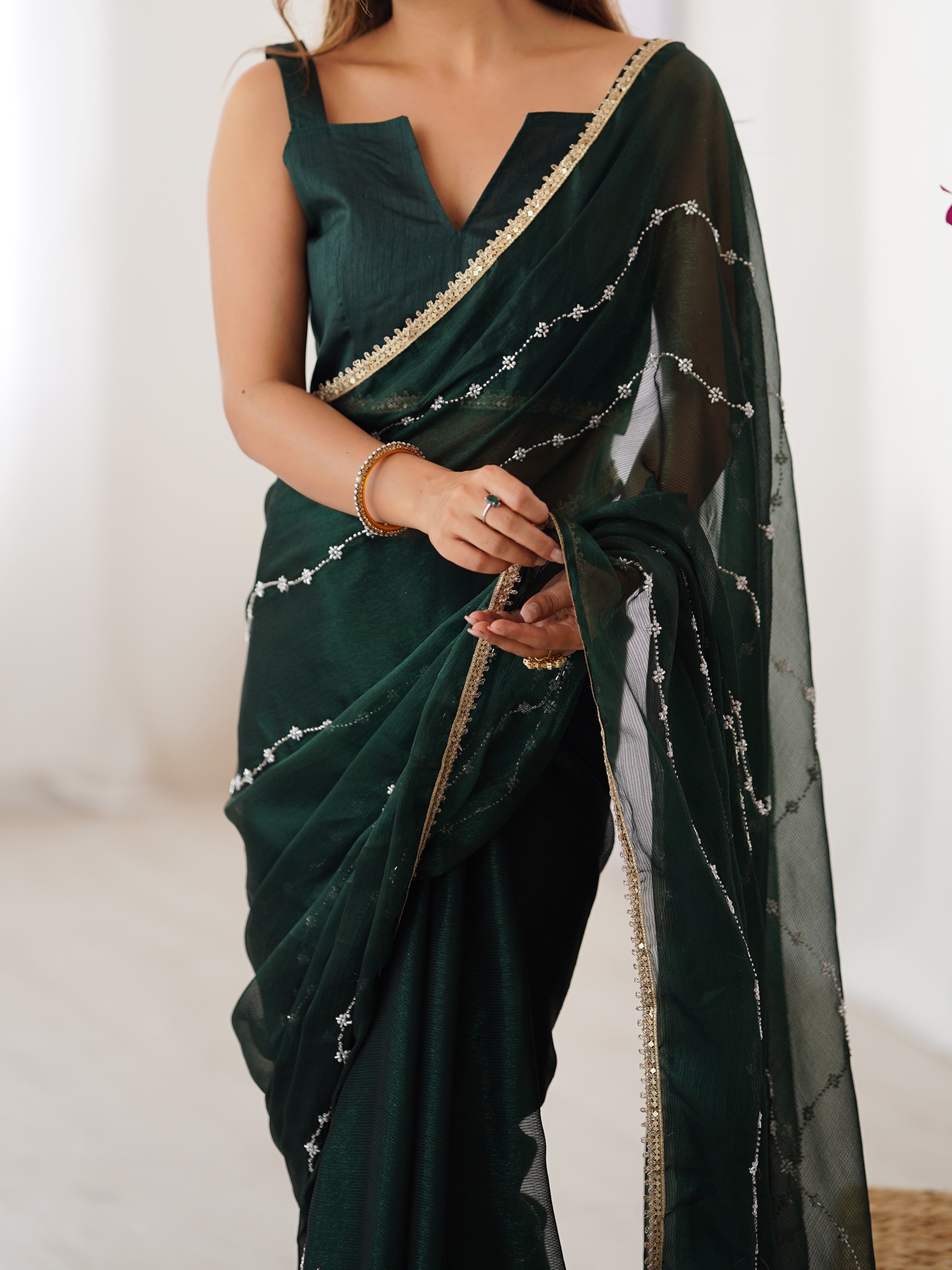 Model posing confidently in Green Sitara Fabric Saree, highlighting embellishments.