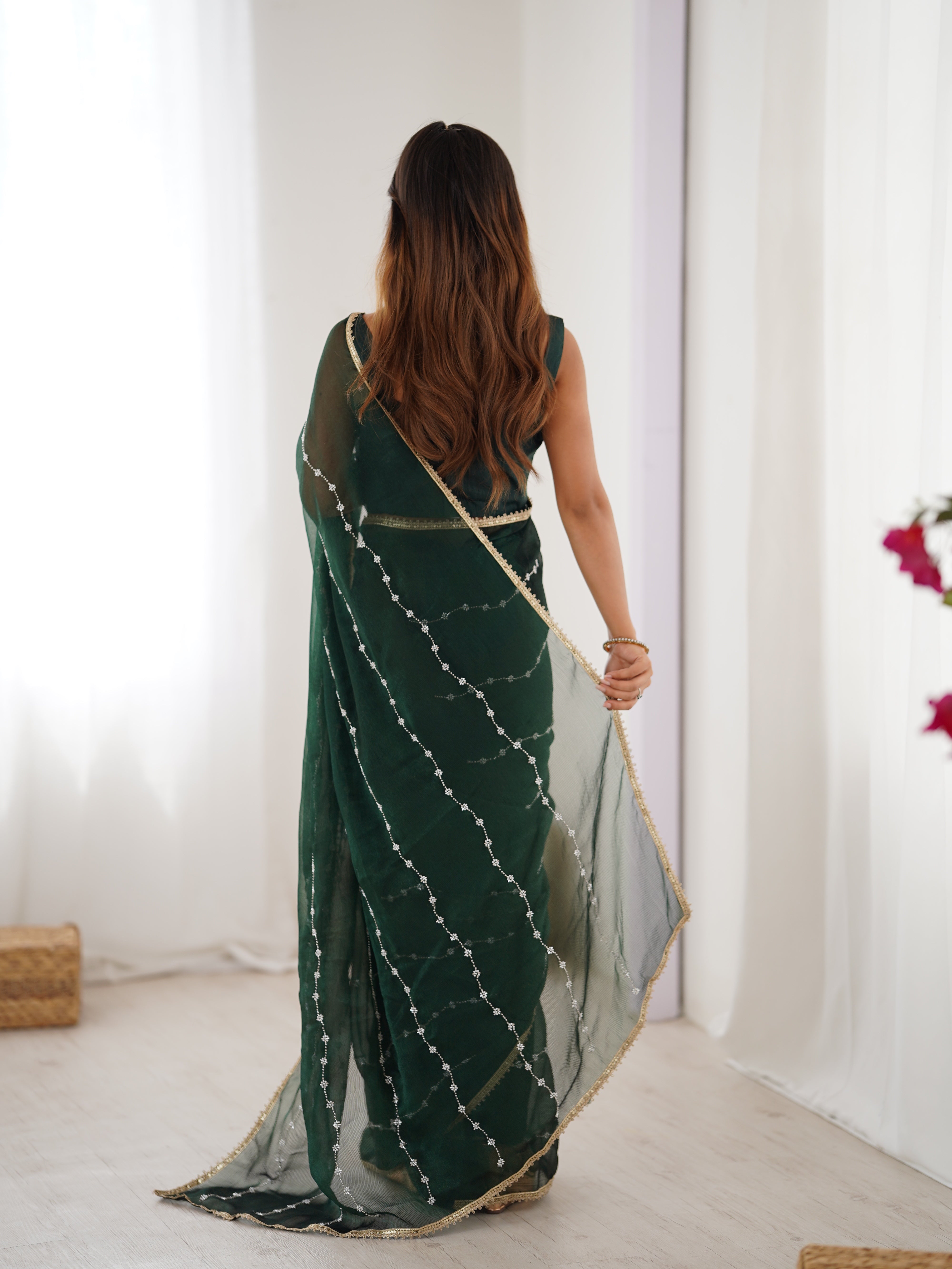 Detailed shot of Green Sitara Saree's border and matching unstitched blouse with lace.