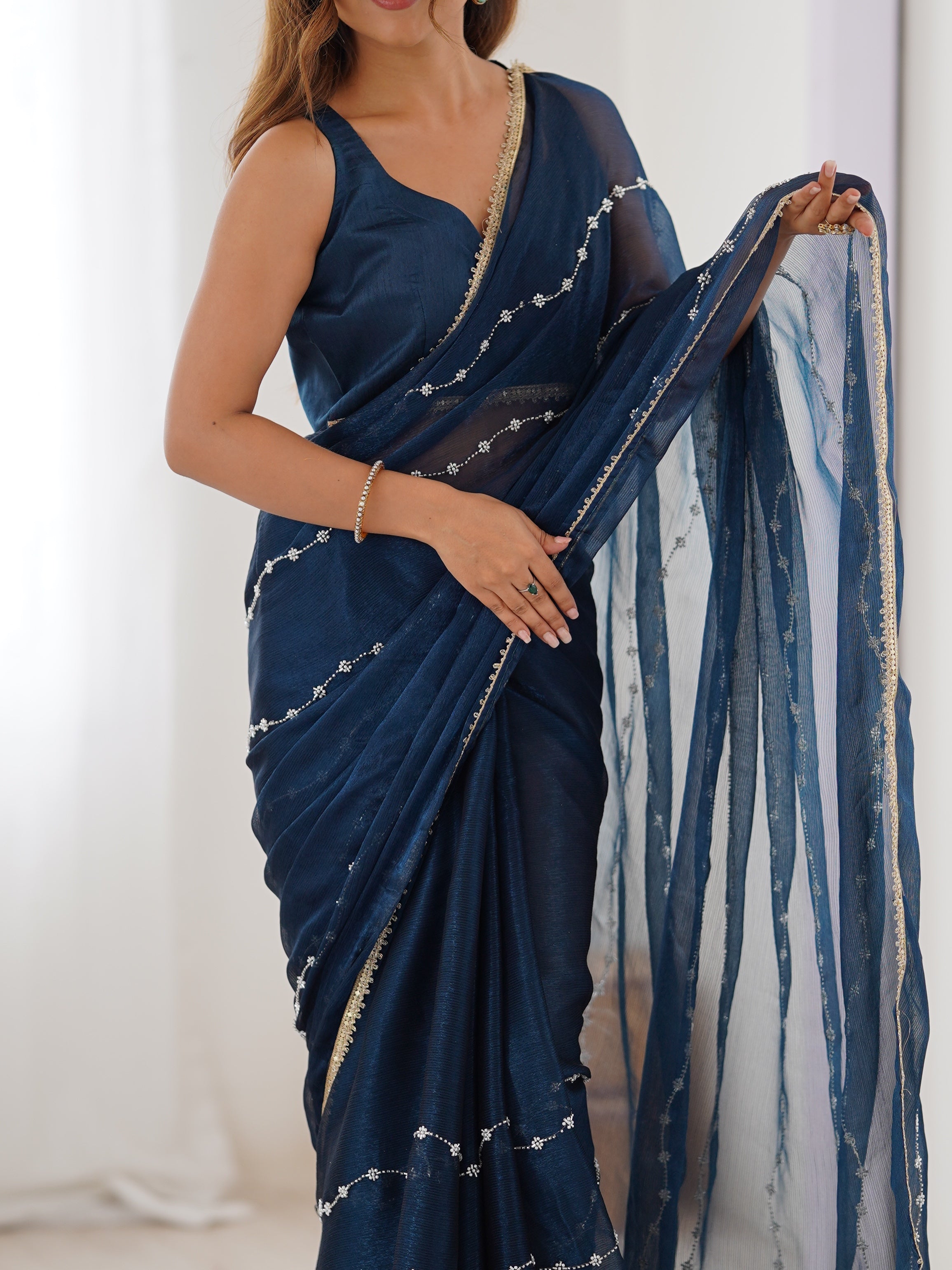 Back view of model in Petrol Blue Sitara Saree, showcasing pallu and full length.