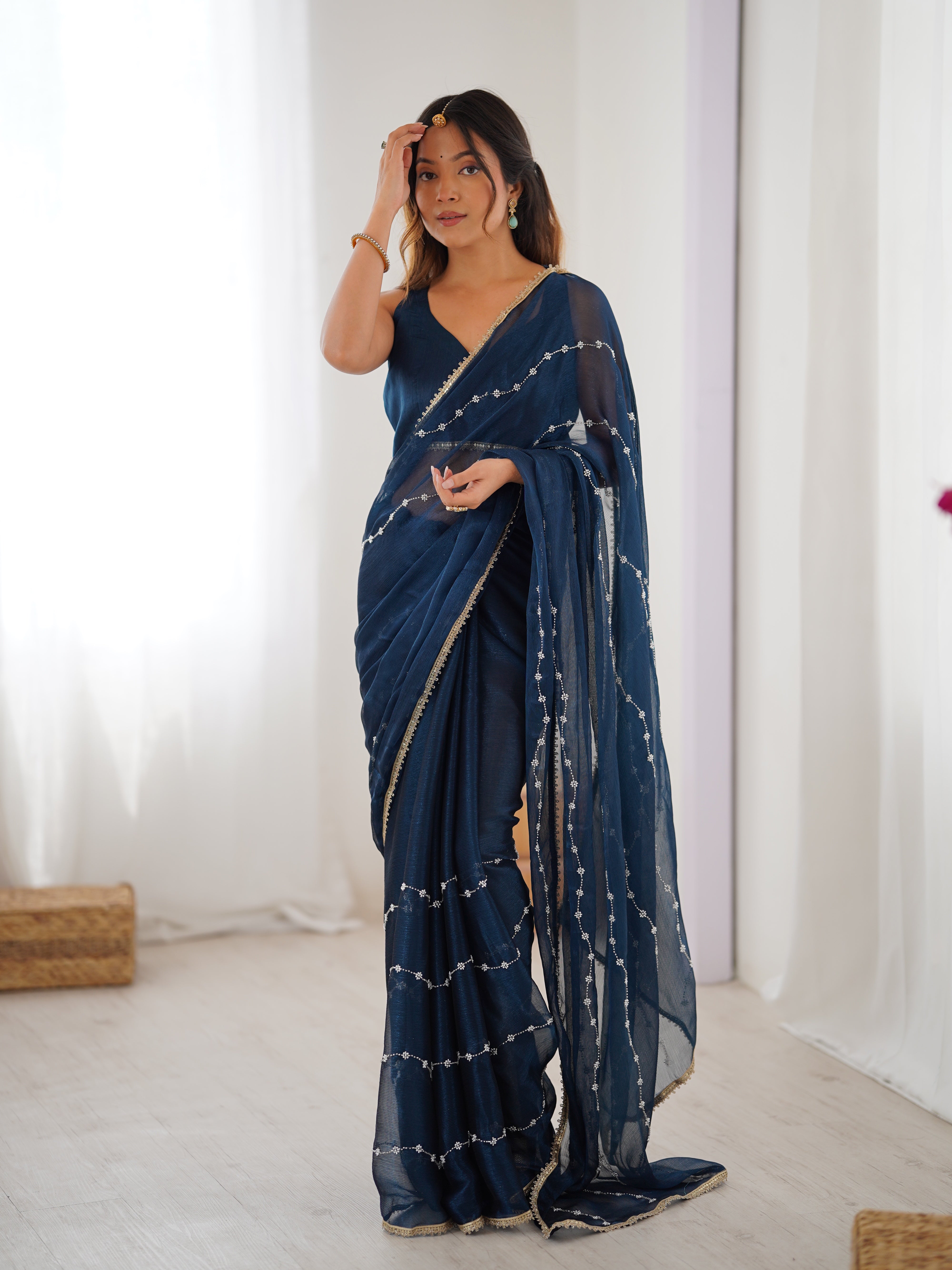 Model posing confidently in Petrol Blue Sitara Fabric Saree, highlighting embellishments.