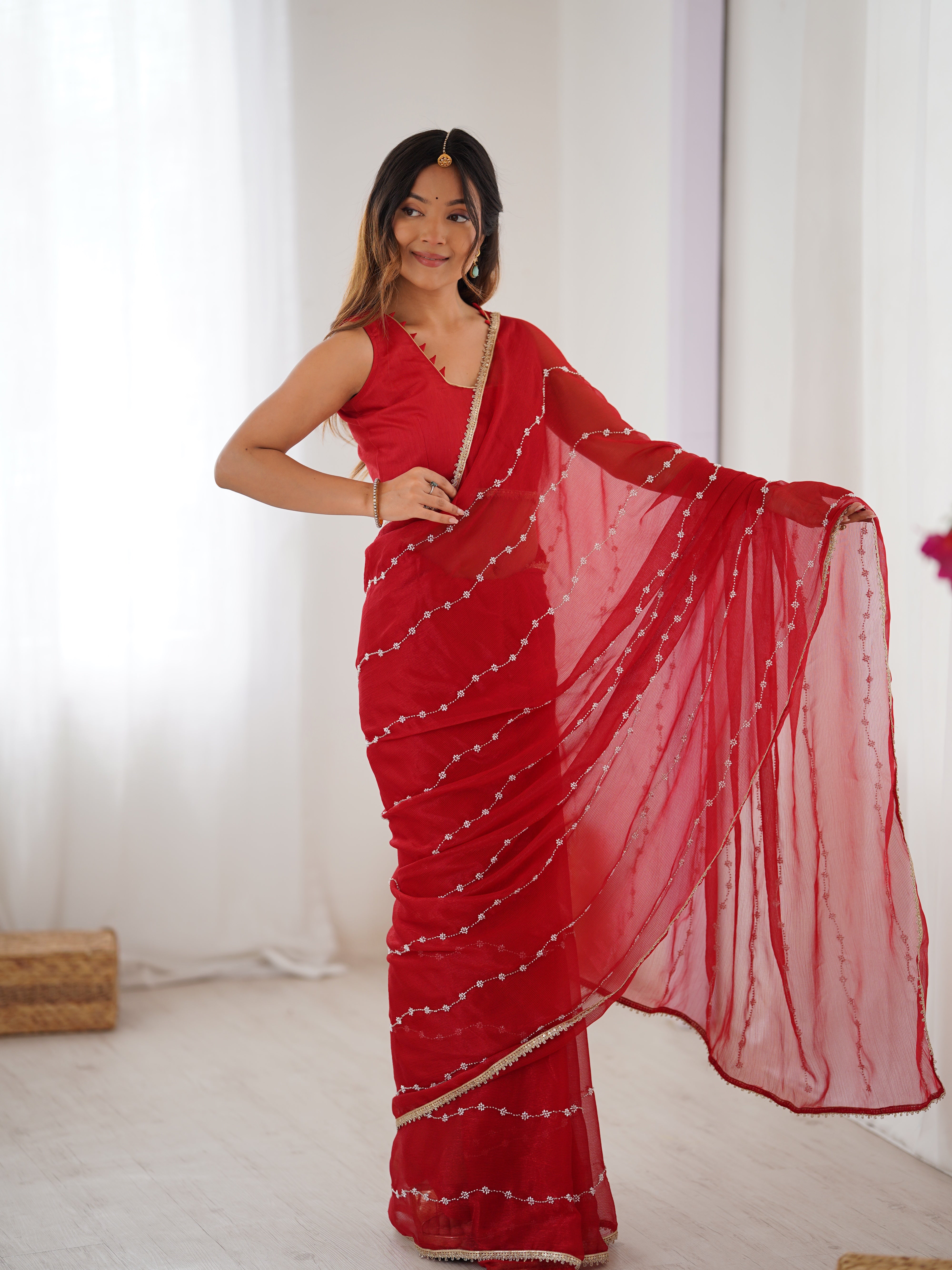Model in Red Sitara Saree, side profile showing graceful drape and bead work.