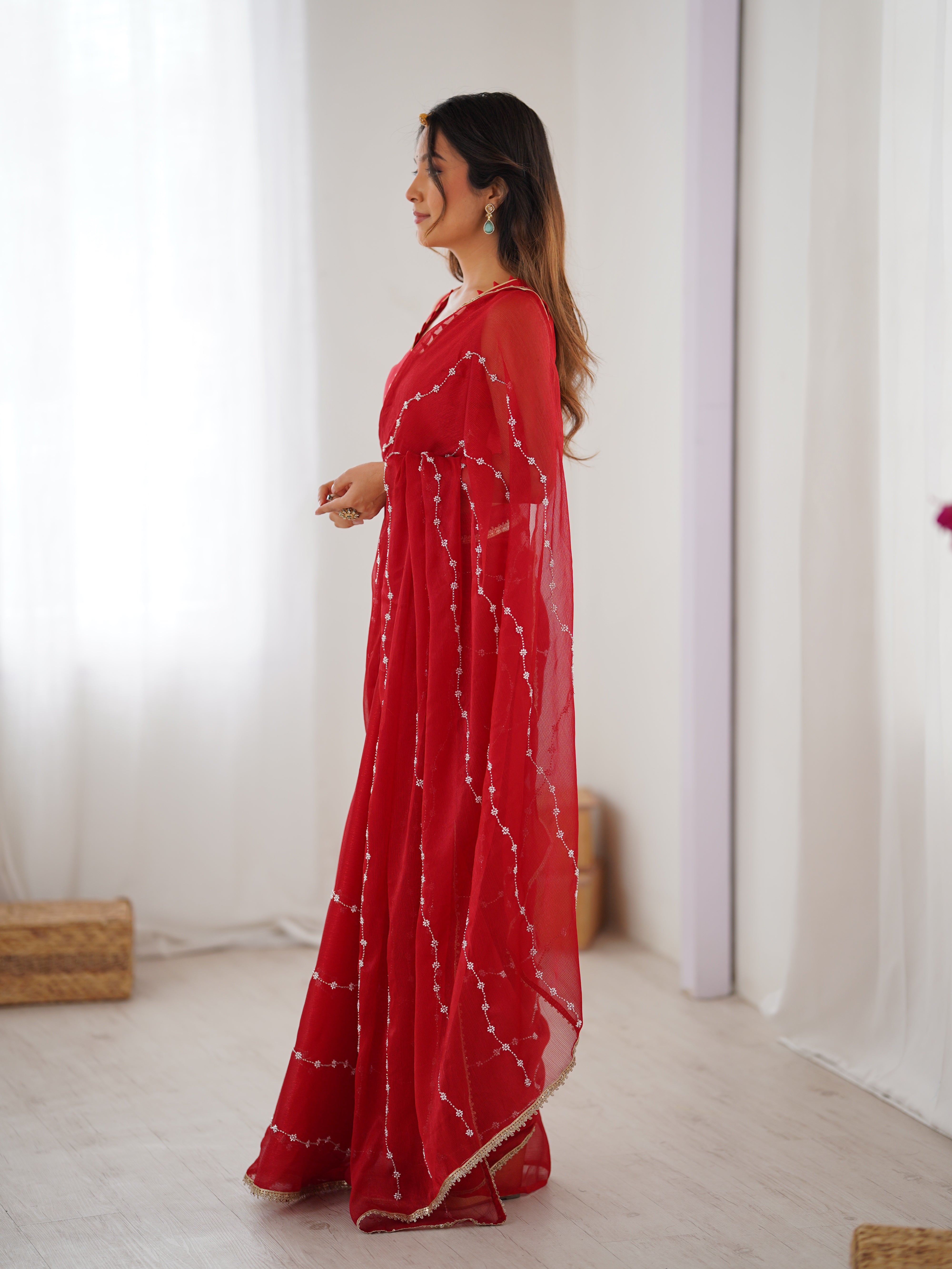 Back view of model in Red Sitara Saree, showcasing pallu and full length.