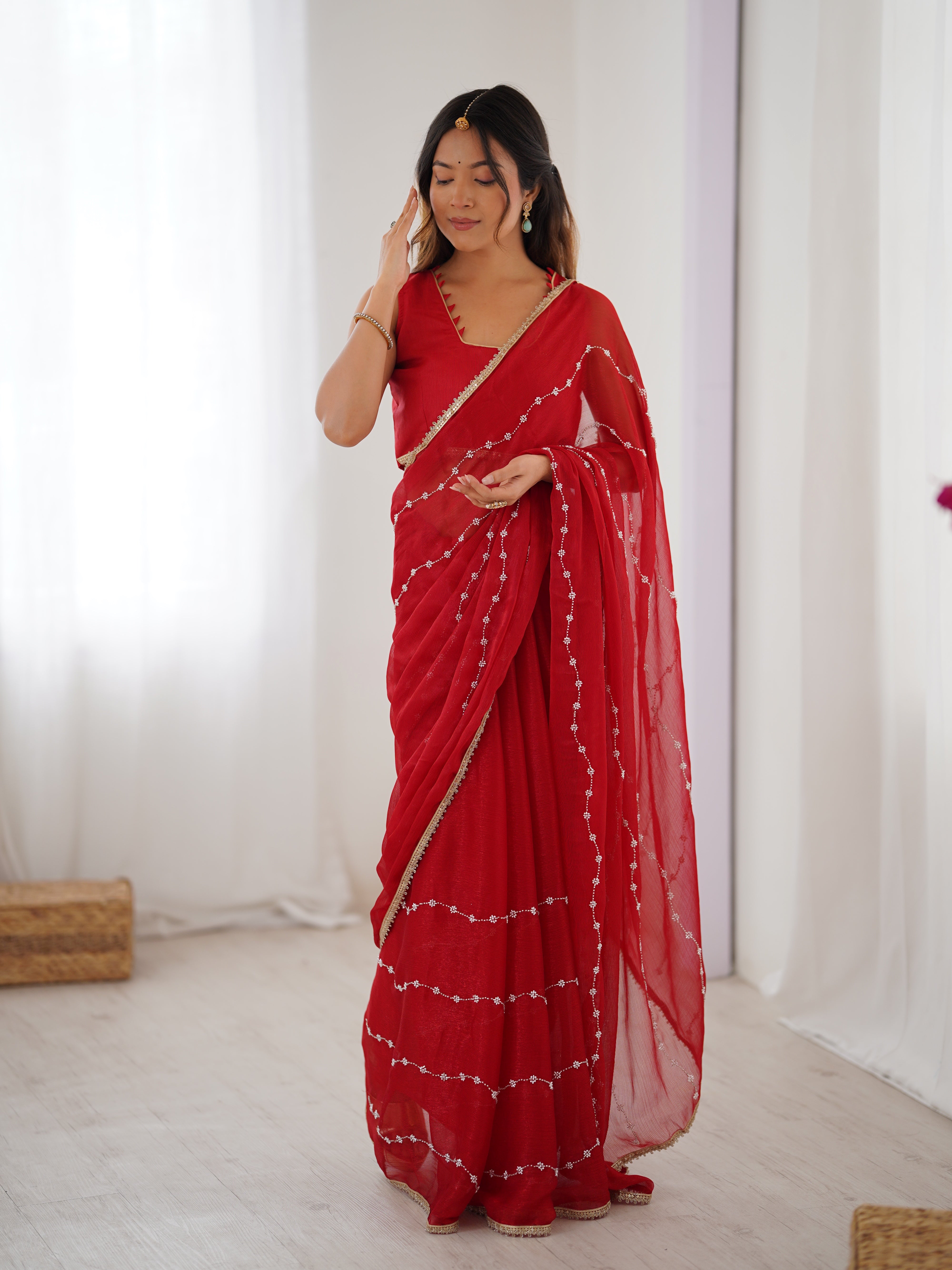 Model posing confidently in Red Sitara Fabric Saree, highlighting embellishments.