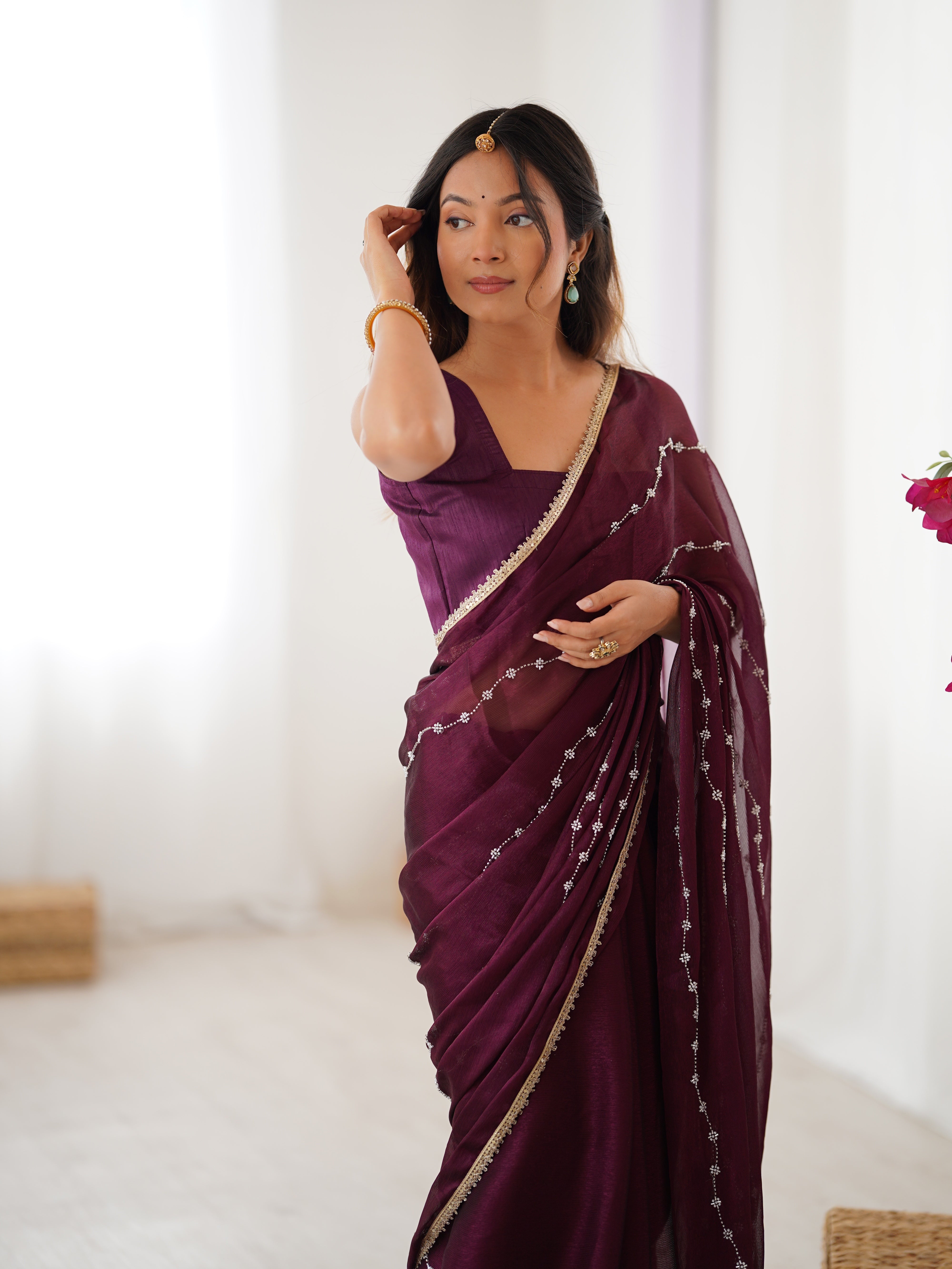 Wine designer saree, close-up of intricate sequin and bead work on Sitara fabric.