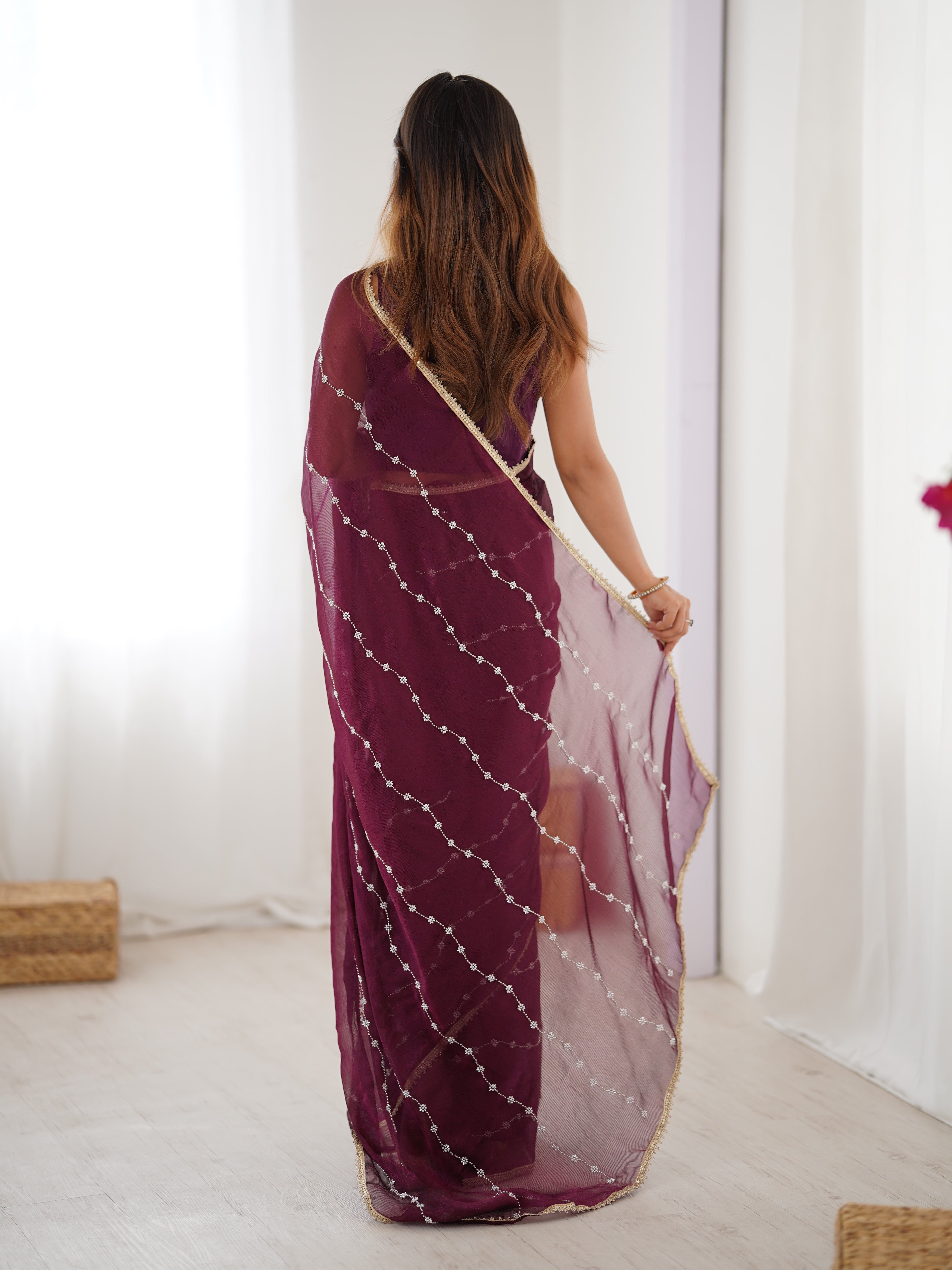 Model posing confidently in Wine Sitara Fabric Saree, highlighting embellishments.