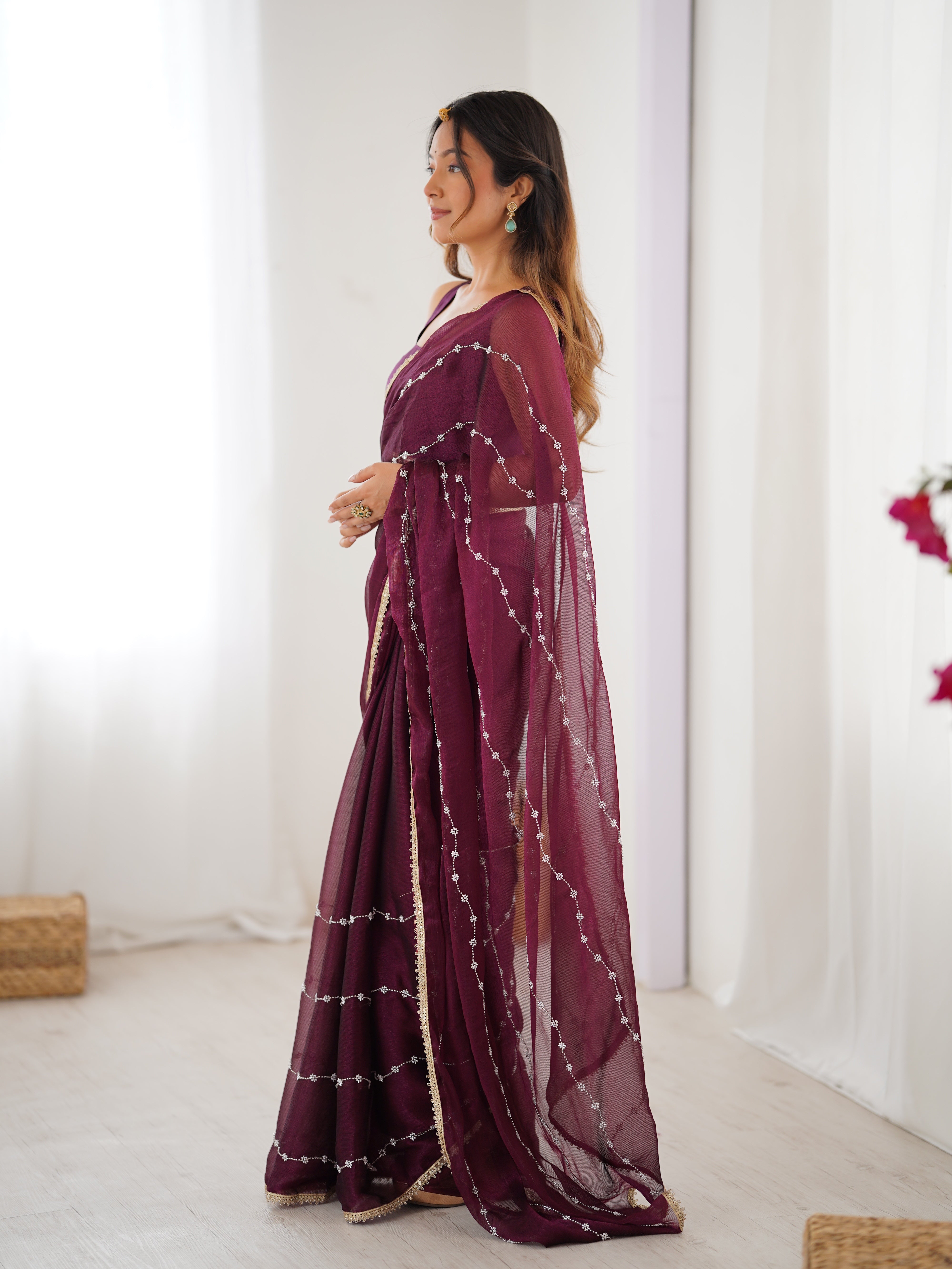Graceful movement of Wine Sitara Saree, with flowing pallu and shimmering sequin design.