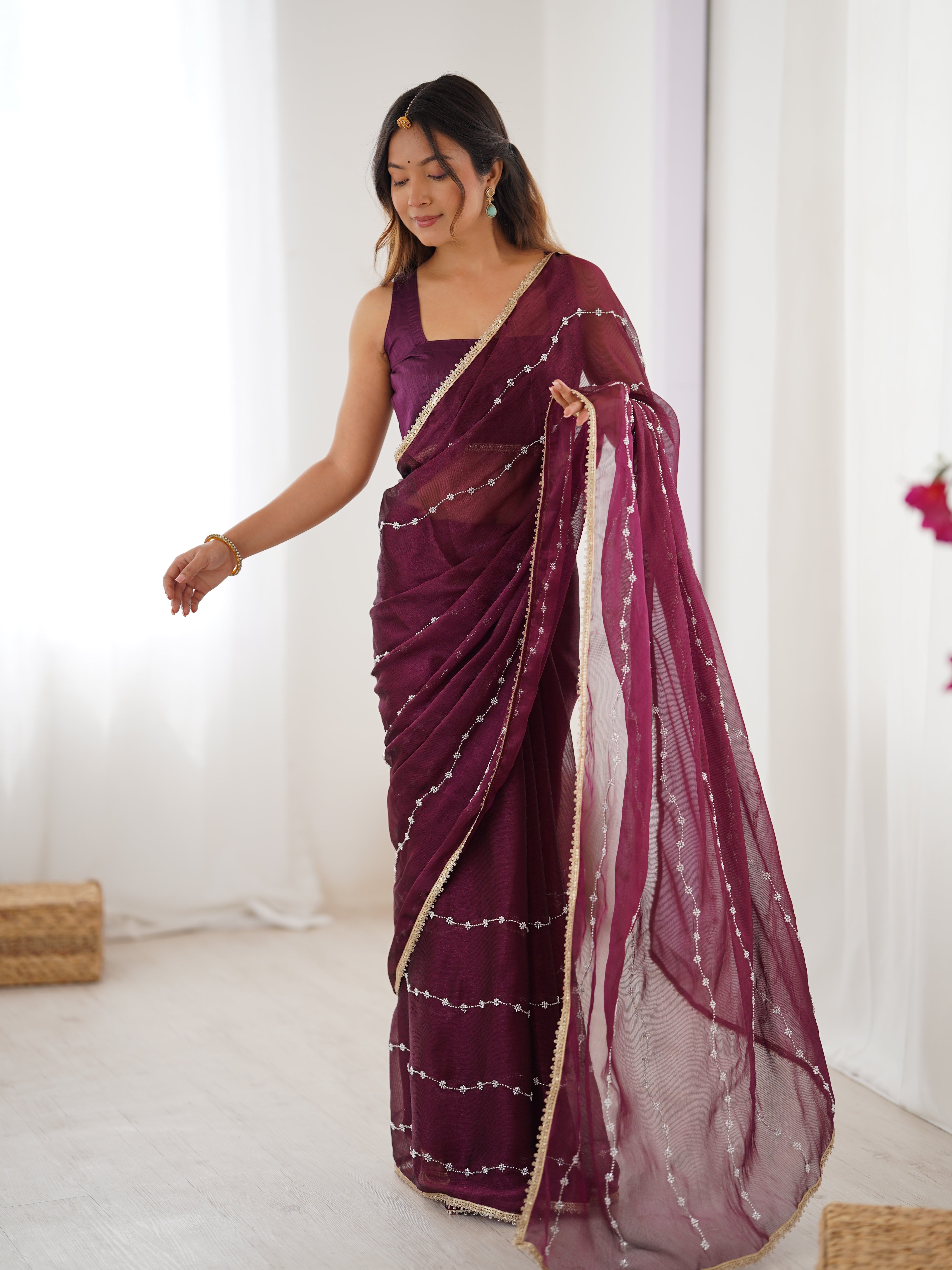 Detailed shot of Wine Sitara Saree's border and matching unstitched blouse with lace.