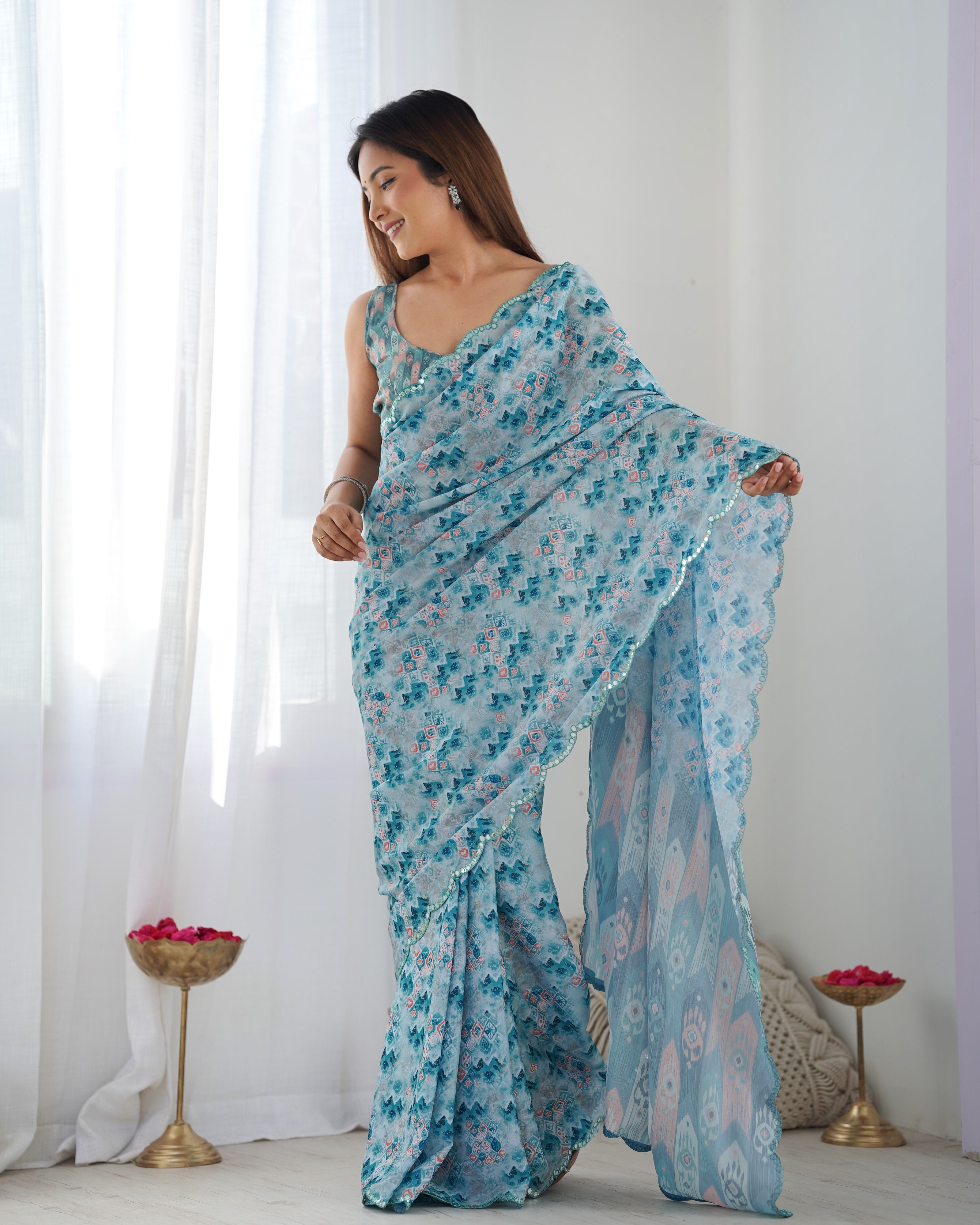 Heavy Chinnon Saree with elegant print & Kutchi mirror lace border. Unstitched blouse included