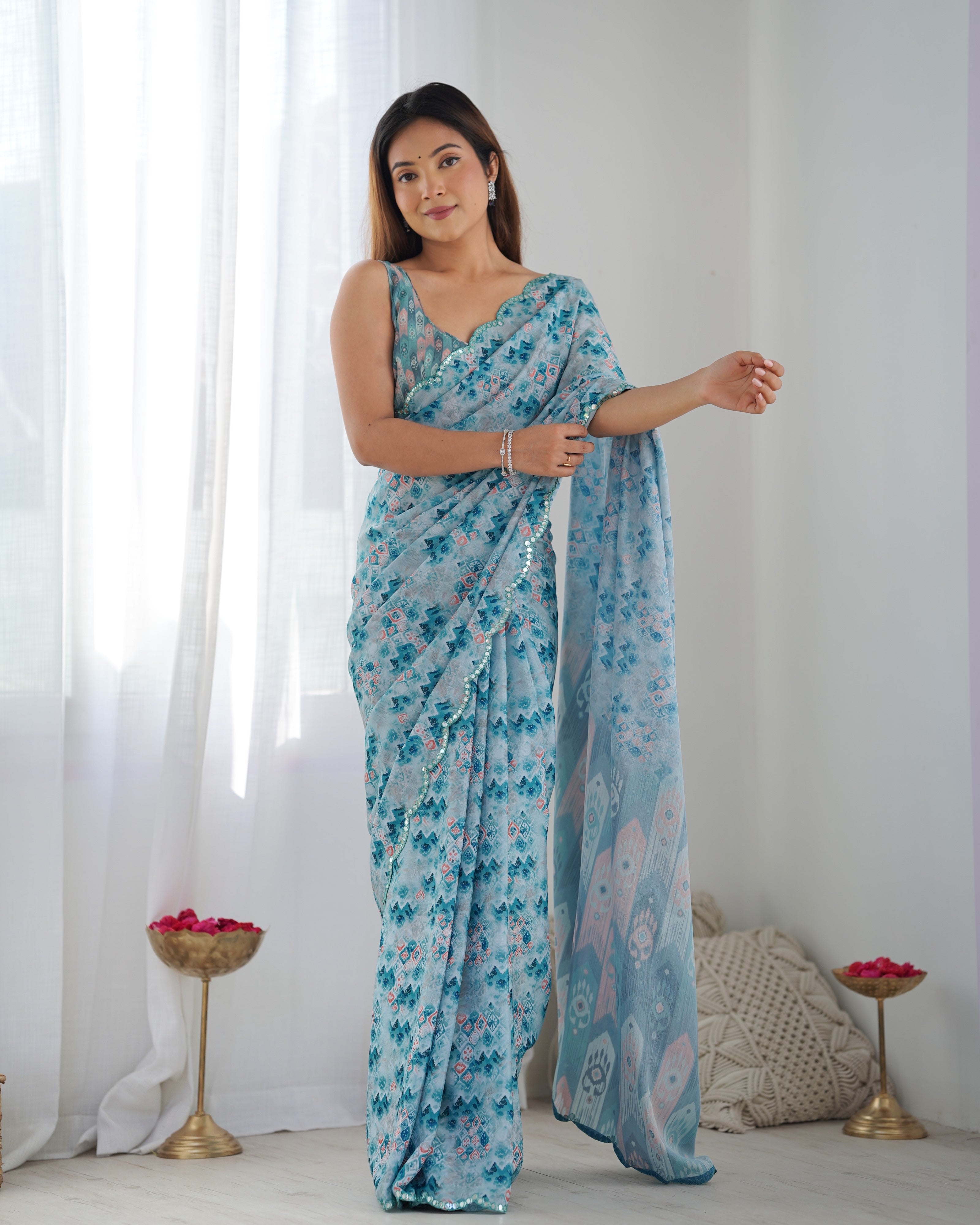 Woman in elegant printed heavy chinnon saree with Kutchi mirror lace border.