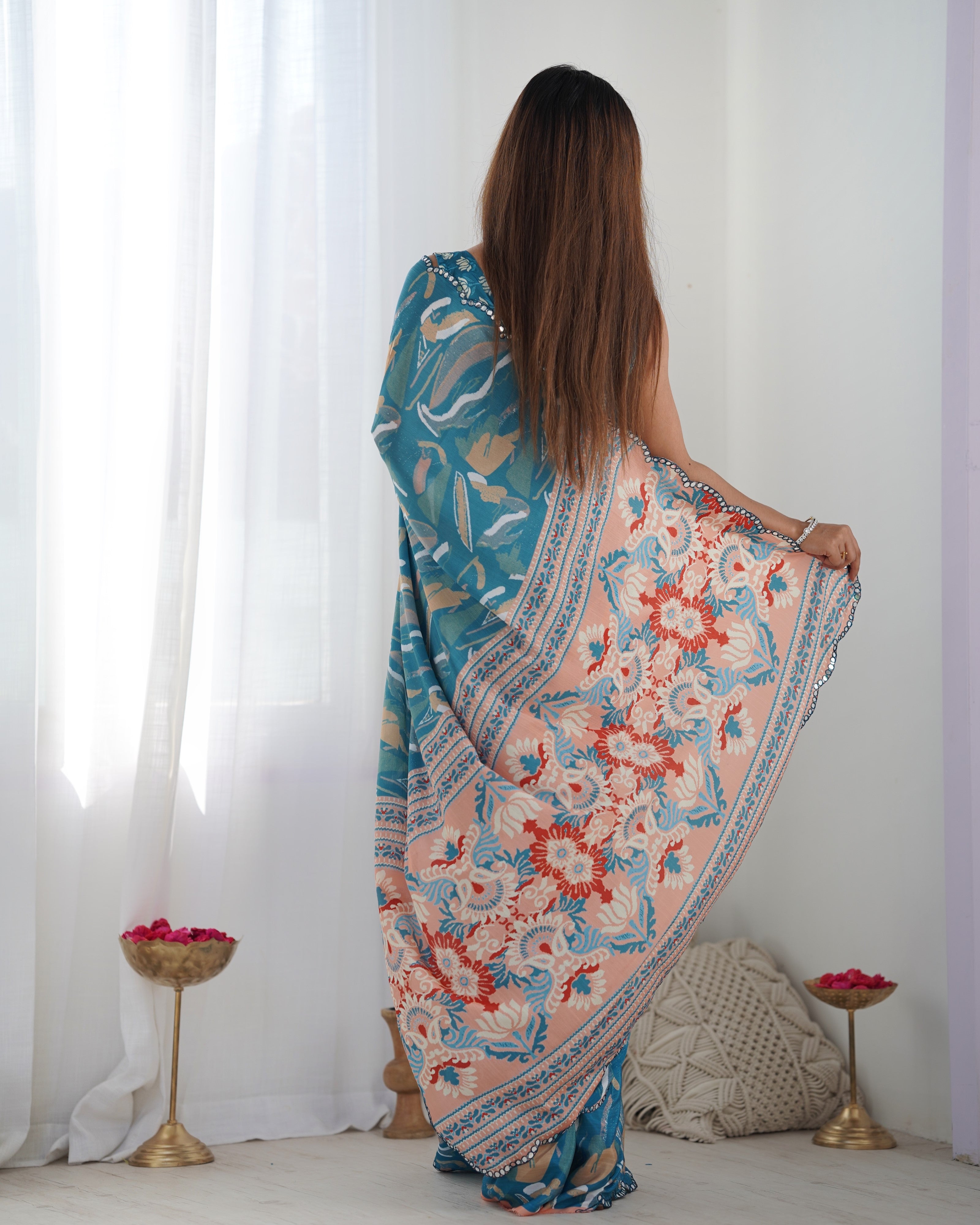 Elegant woman modeling a Heavy Chinnon Saree with Kutchi mirror lace and detailed print work.