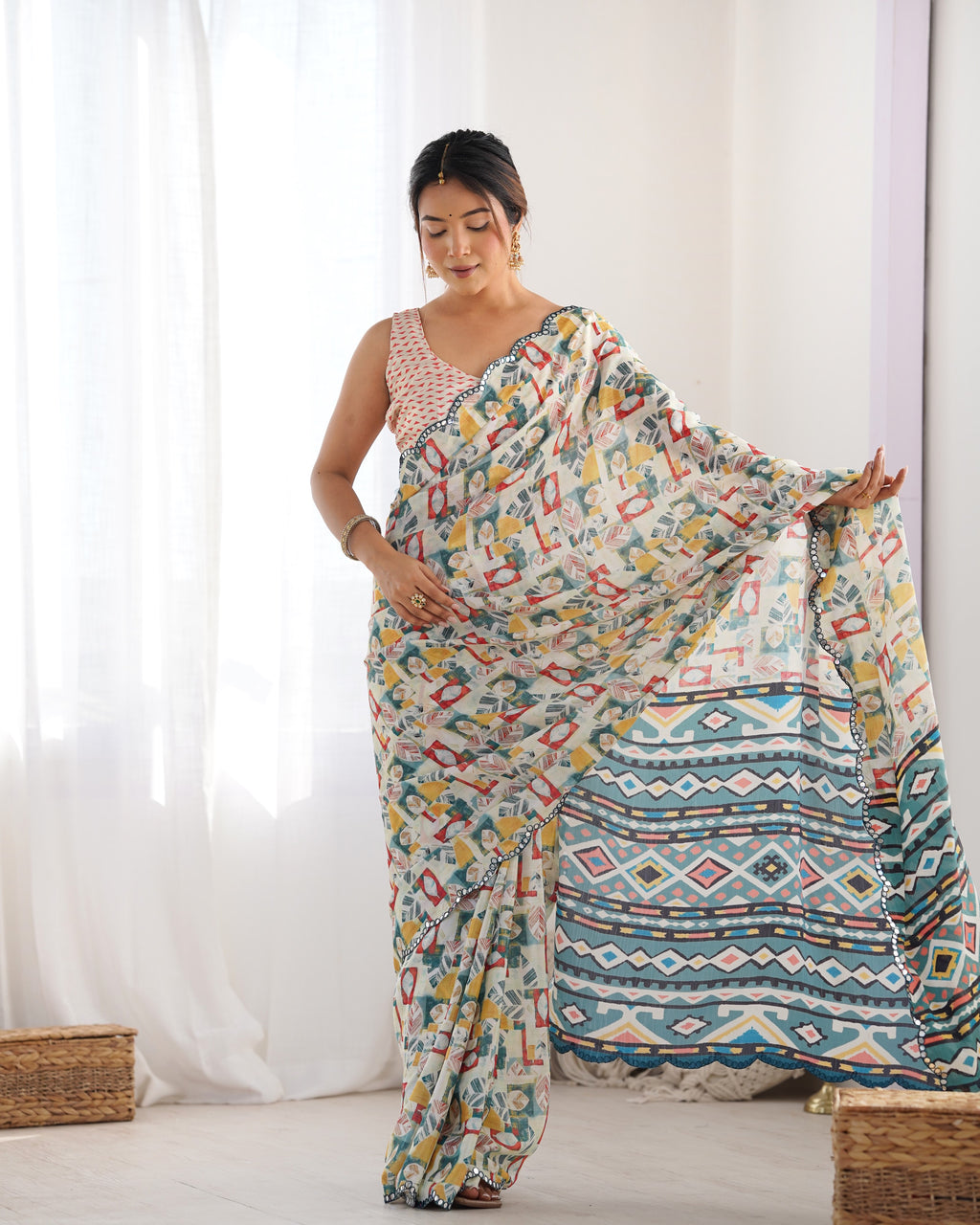 Woman wearing a heavy Chinnon saree with beautiful Kutchi work and mirror lace border.