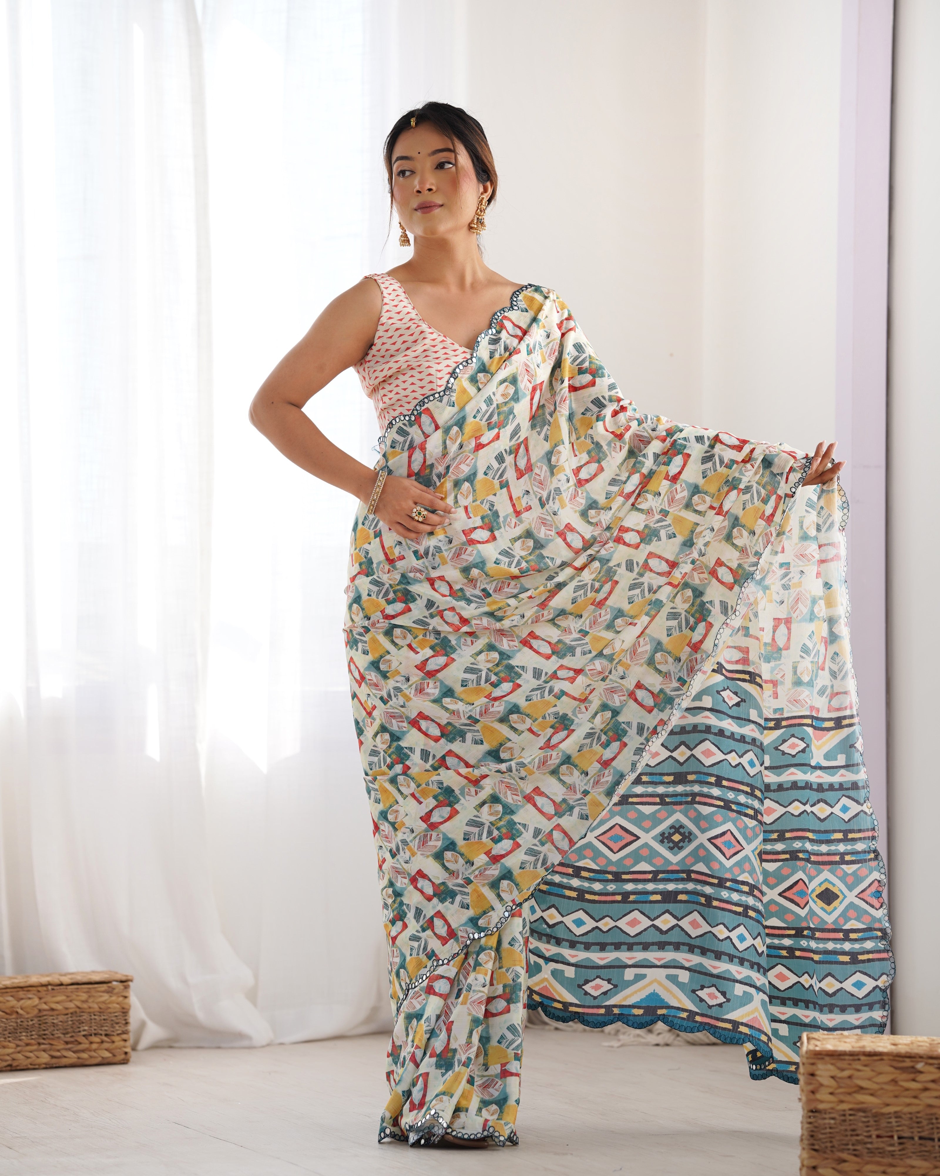 Heavy Chinnon saree with intricate Kutchi work and a shimmering mirror lace border.
