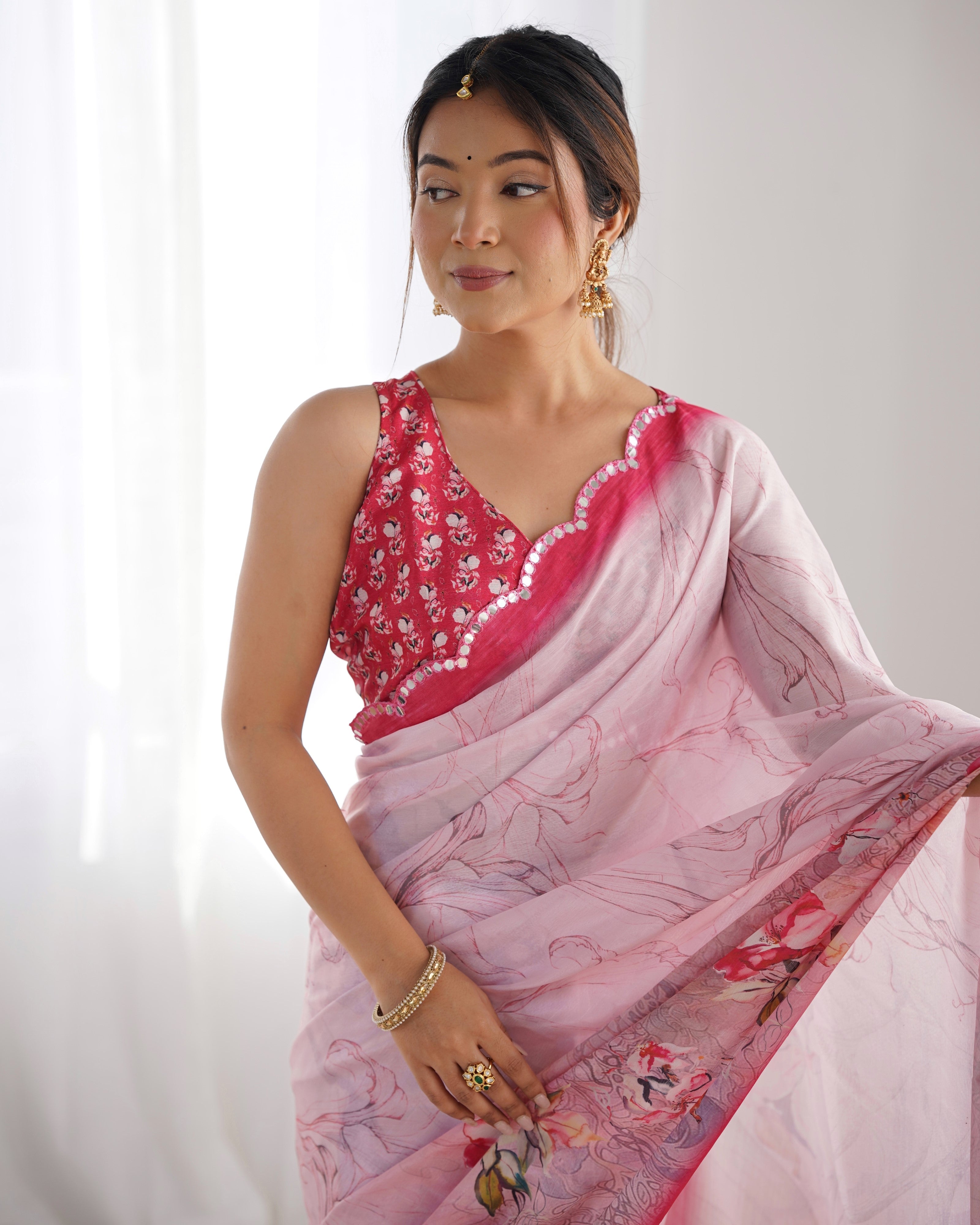 Elegant Heavy Chinnon Saree with Kutchi mirror work and floral print blouse.