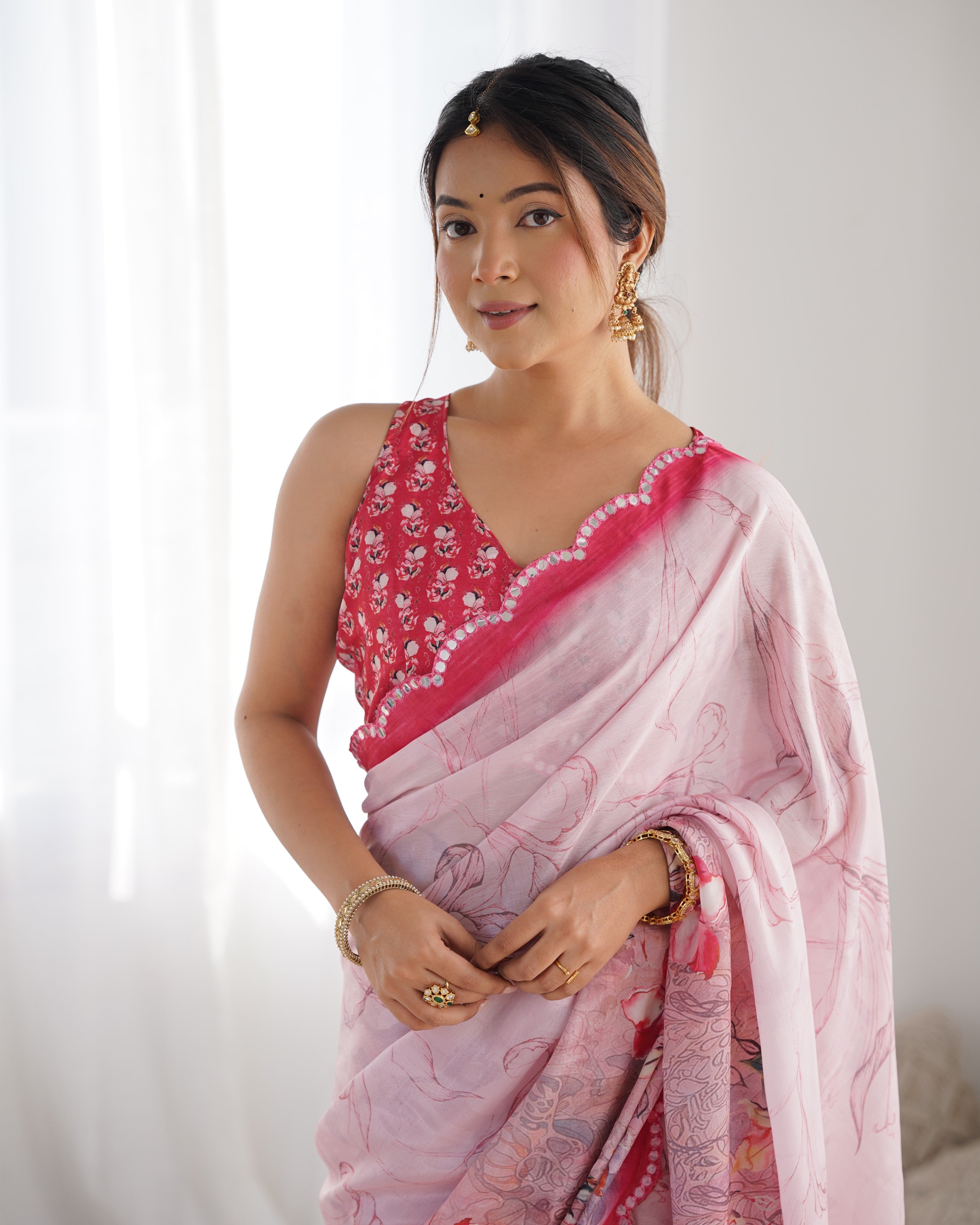 Elegant heavy Chinnon saree with Kutchi mirror work details and a vibrant floral print blouse.