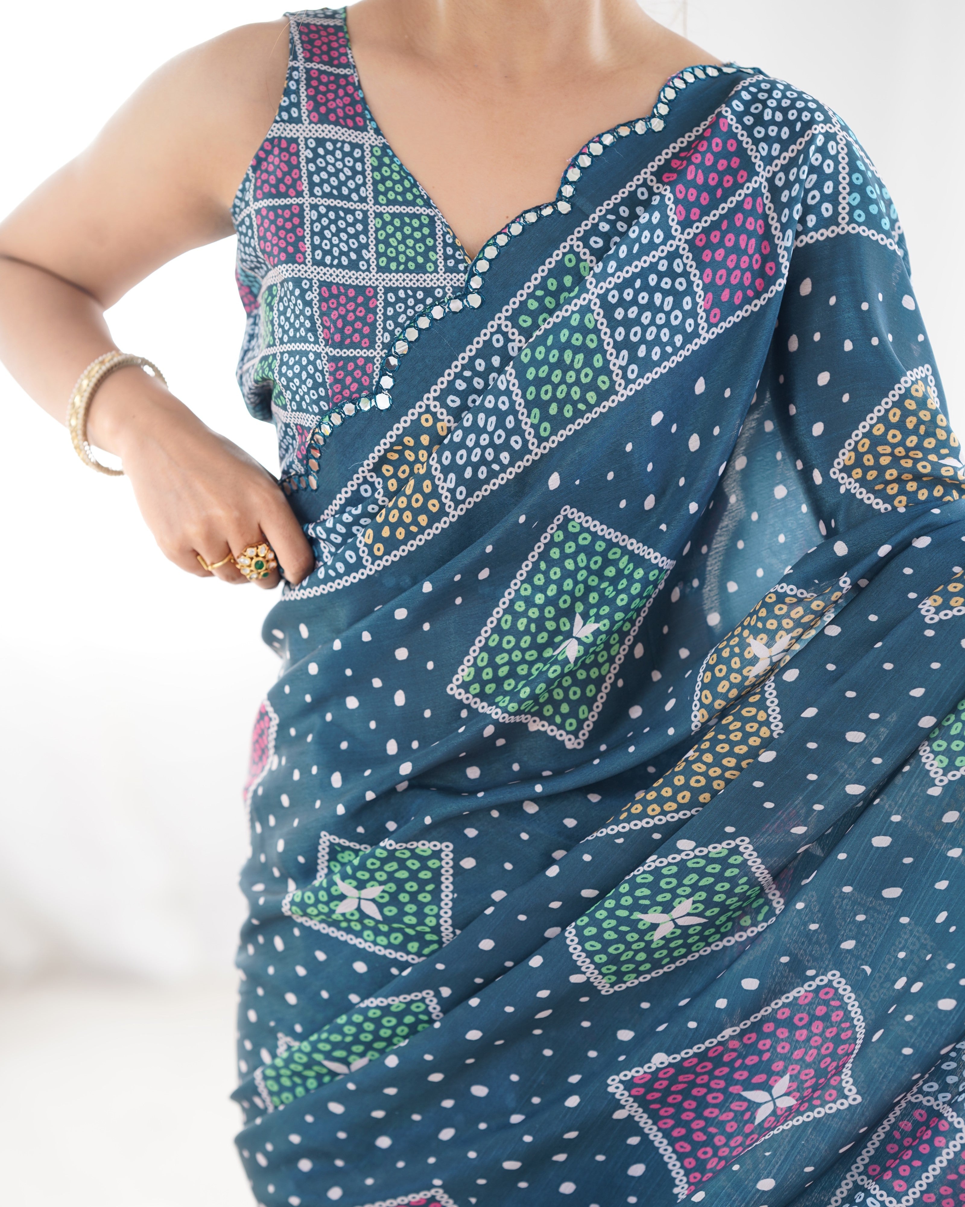 Elegant Teal Heavy Chinnon Saree featuring Kutchi mirror work lace border.
