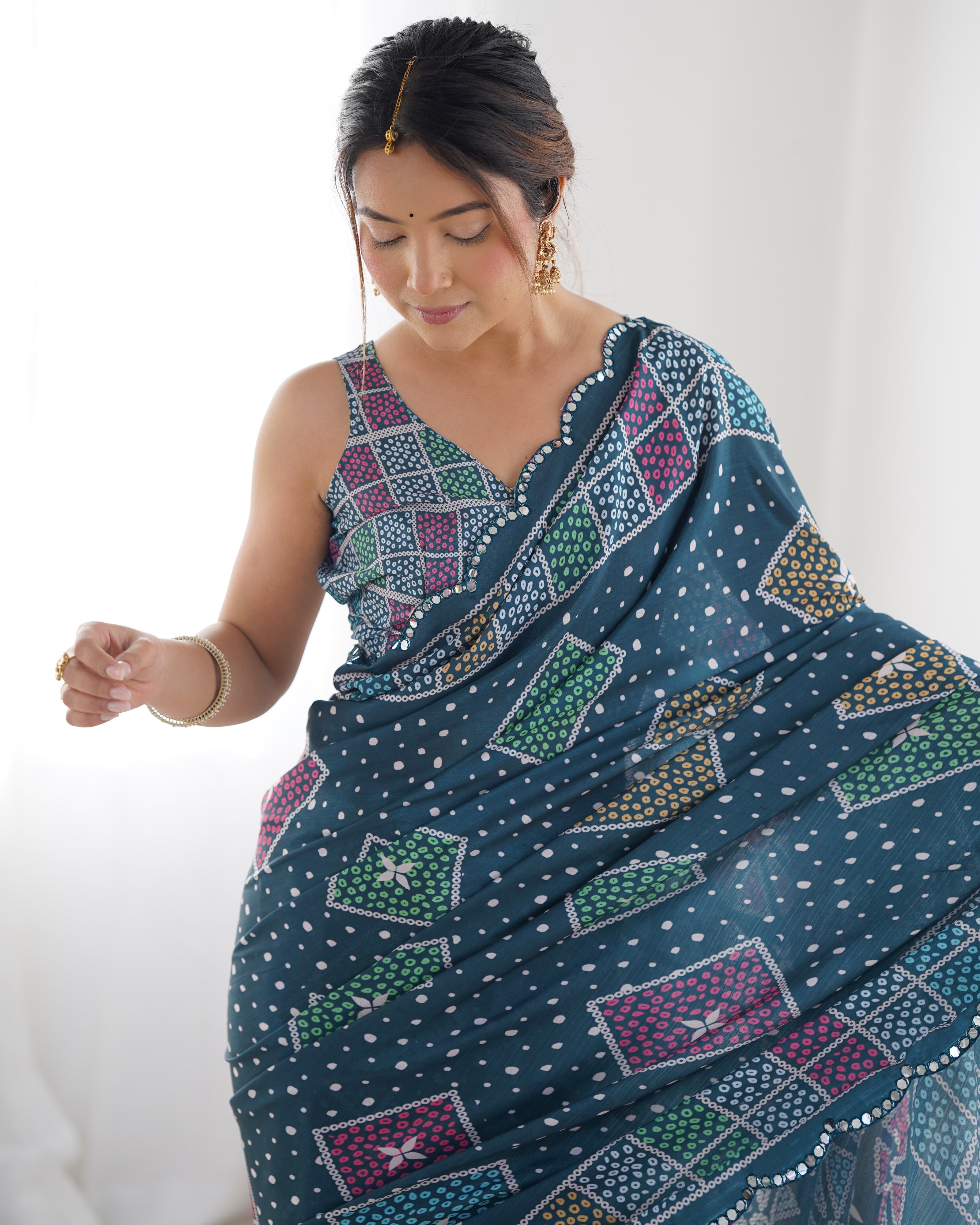 Elegant teal heavy chinnon saree with Kutchi mirror work lace border