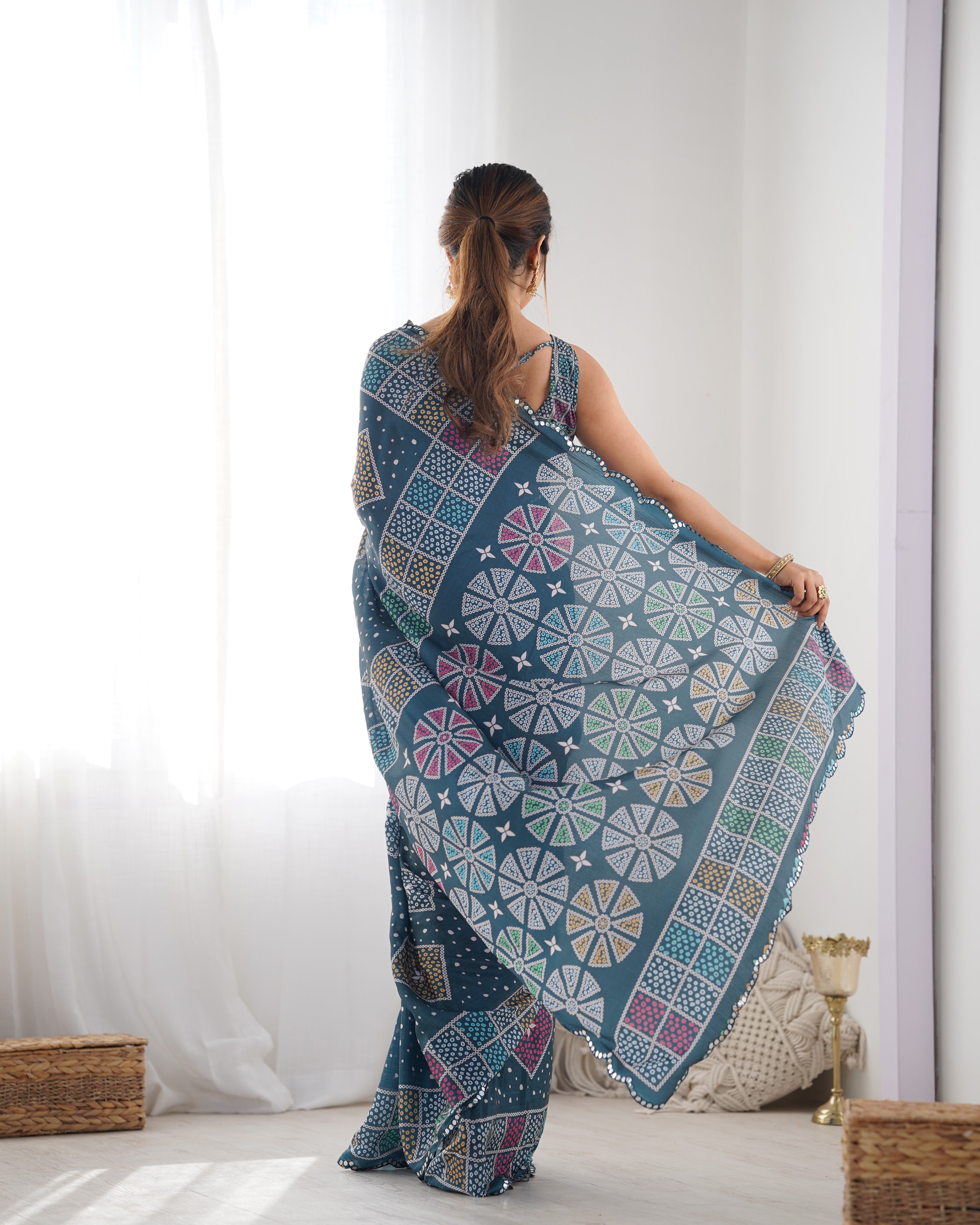 Elegant teal heavy chinnon saree with Kutchi mirror work lace border