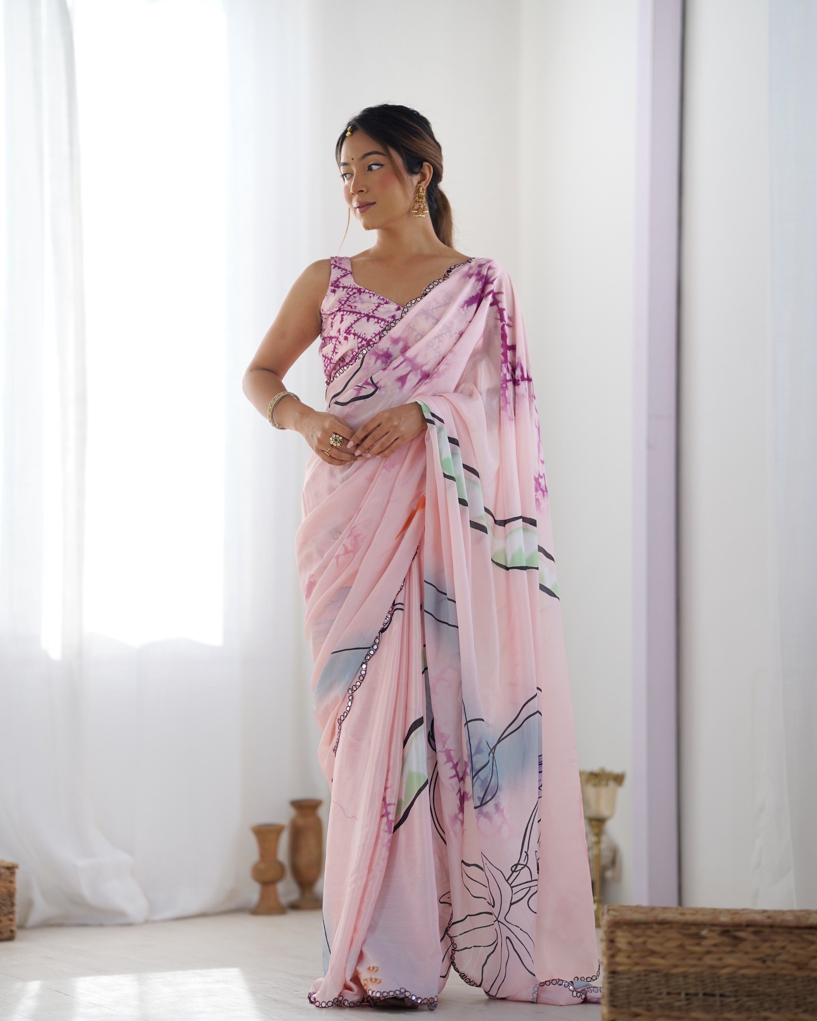 Elegant heavy Chinnon saree with vibrant printed design and intricate Kutchi mirror lace border detail.