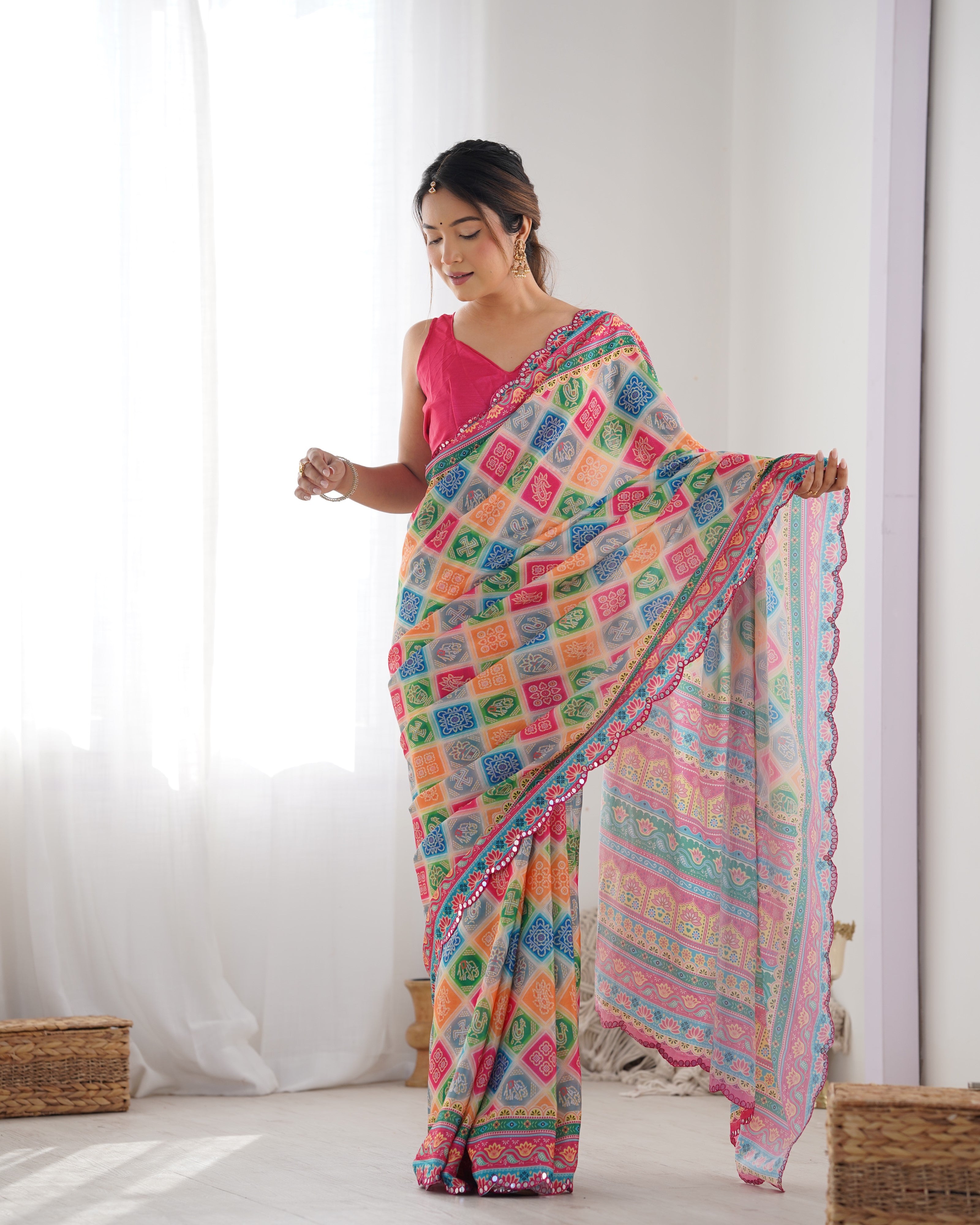 Vibrant print heavy Chinnon saree with traditional Kutchi mirror work border design