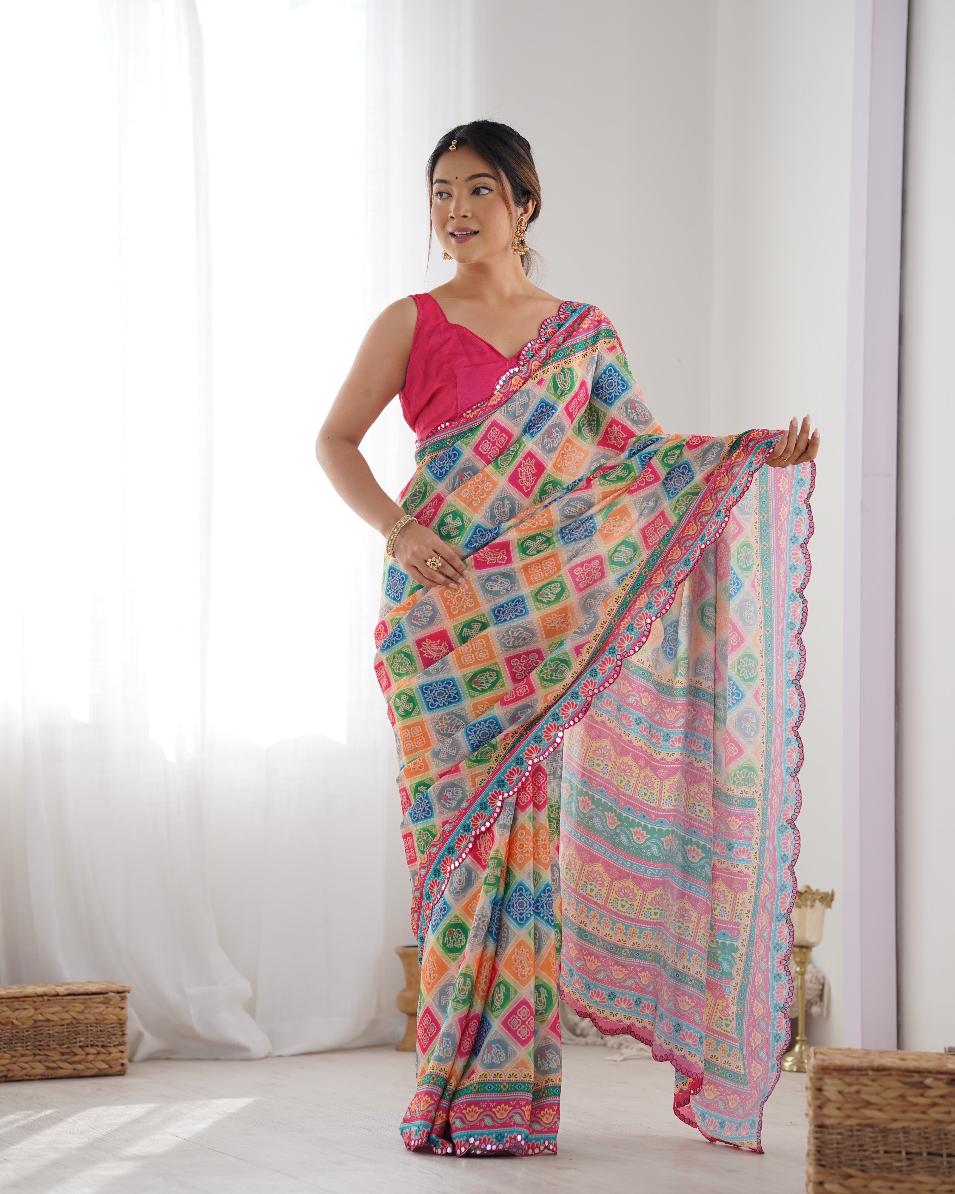 Woman models TRENDBUY Heavy Chinnon Saree with vibrant print and elegant Kutchi mirror work border.