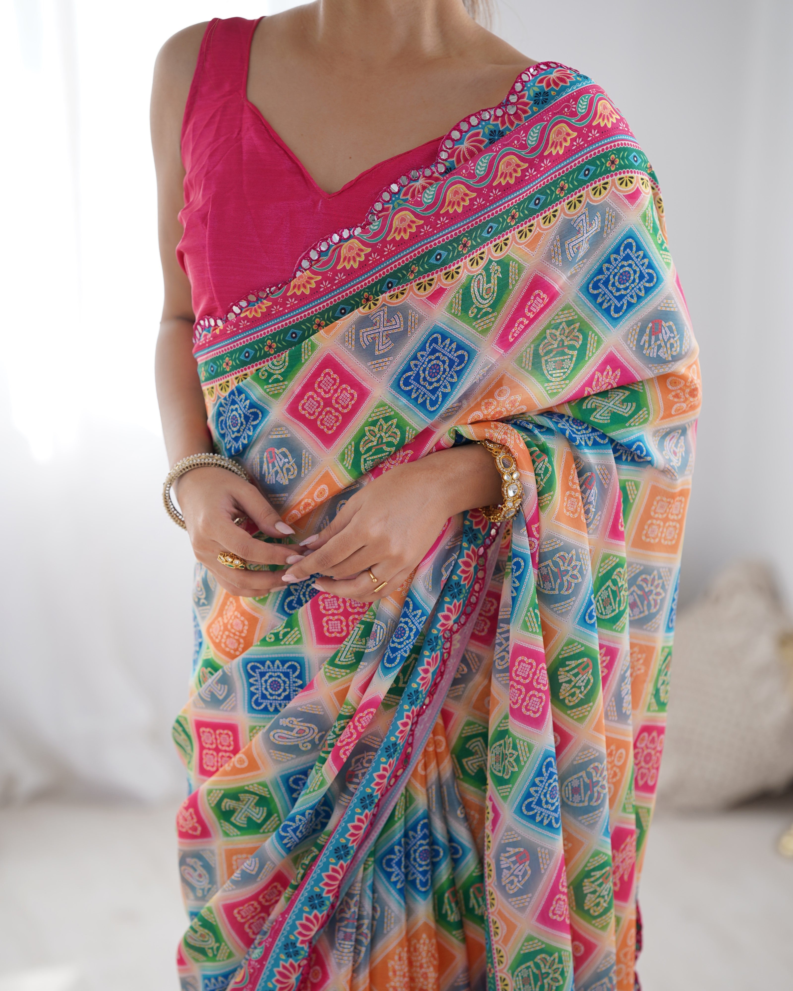 Vibrant print chinnon saree with intricate Kutchi mirror work border detail.