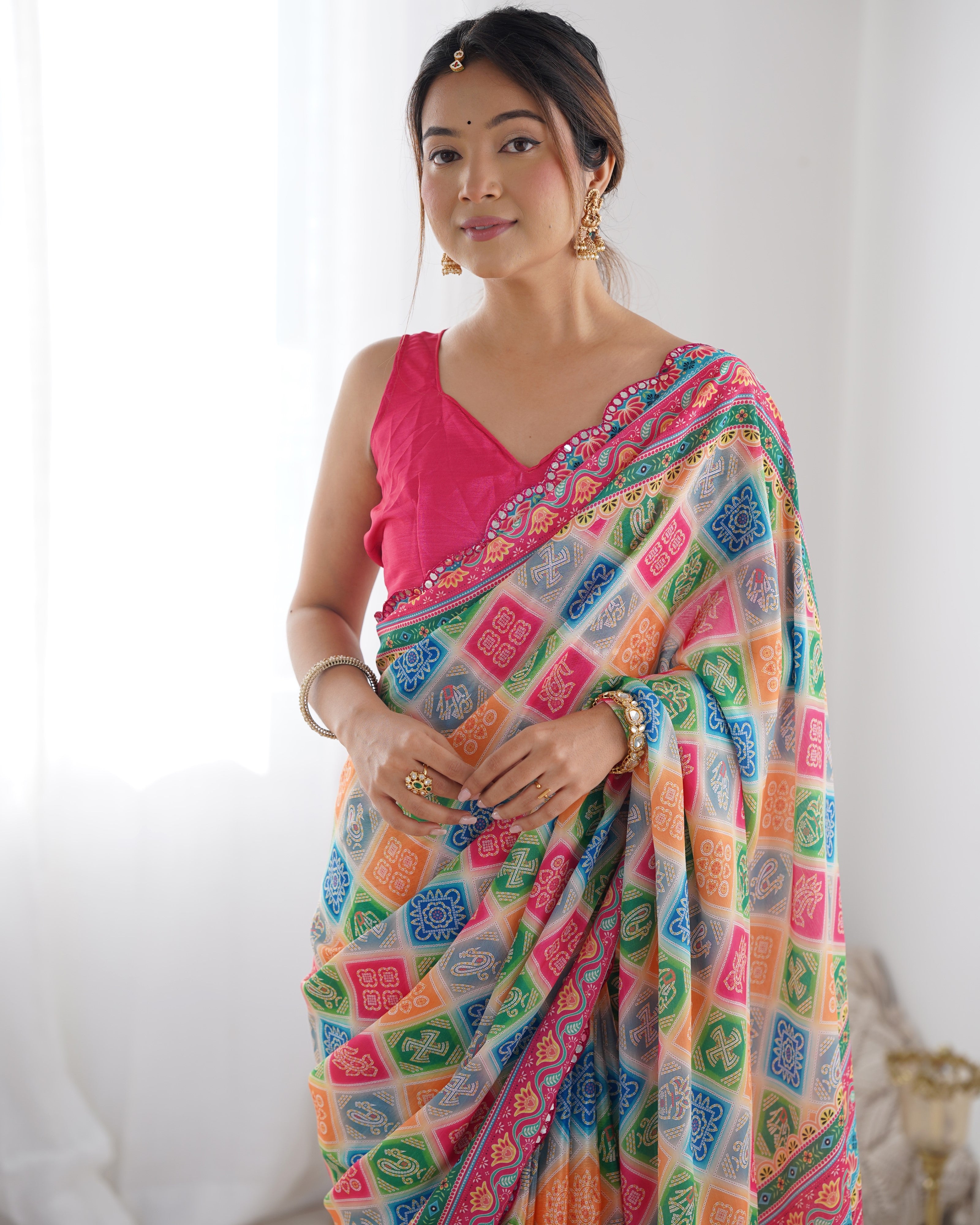 Heavy Chinnon Saree with vibrant print and intricate Kutchi mirror work border detail.