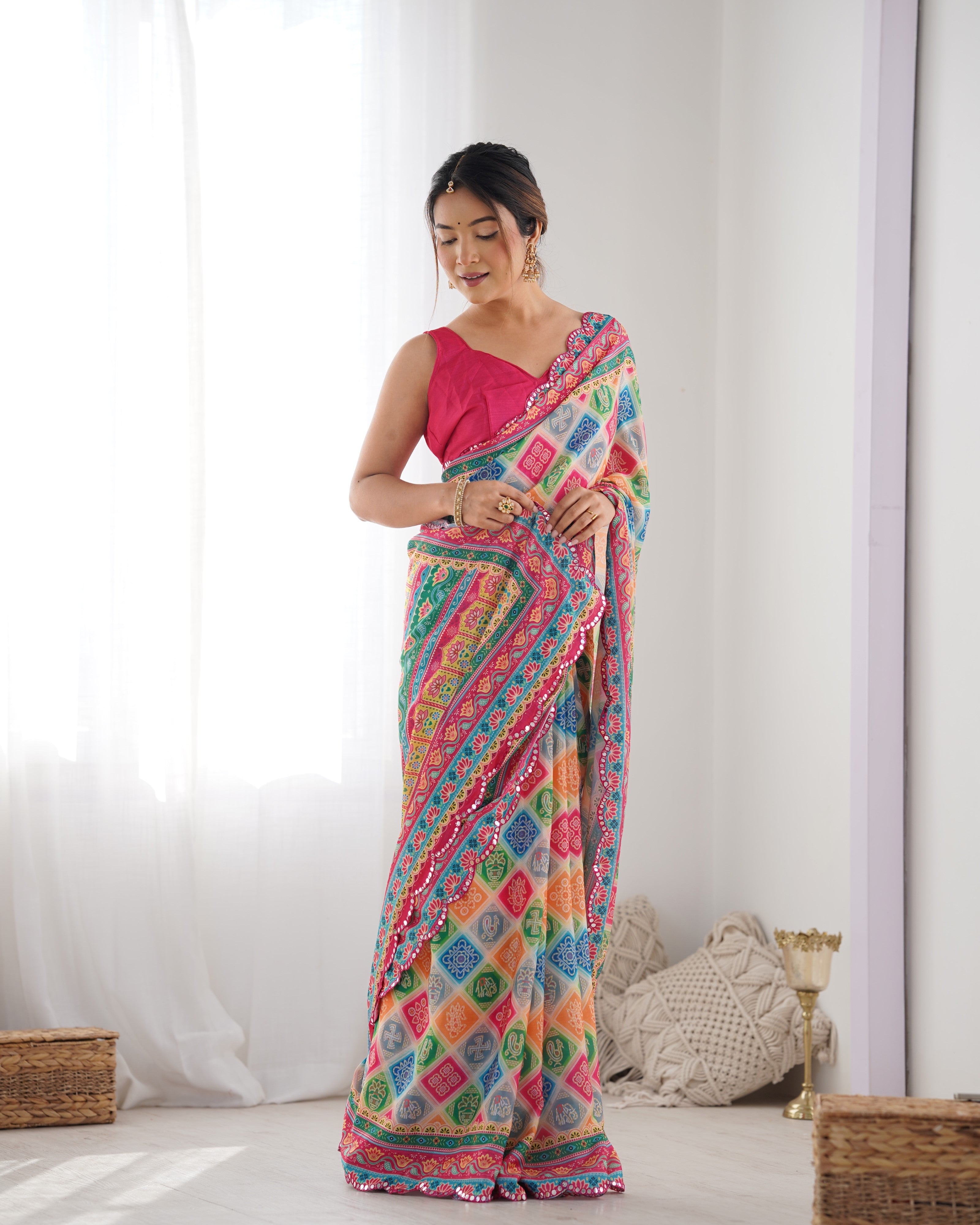 TRENDBUY Heavy Chinnon Saree with vibrant print and Kutchi mirror work border detail.